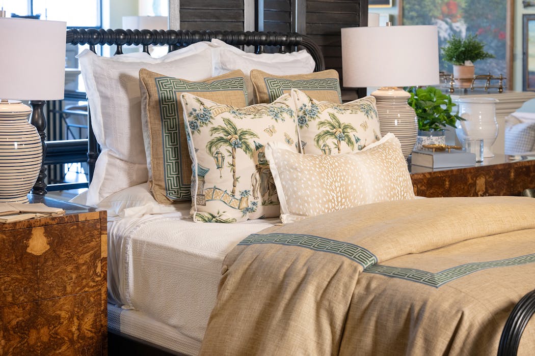 This bedscape creates a serene oasis with its soft wash of neutrals, greens and blues.