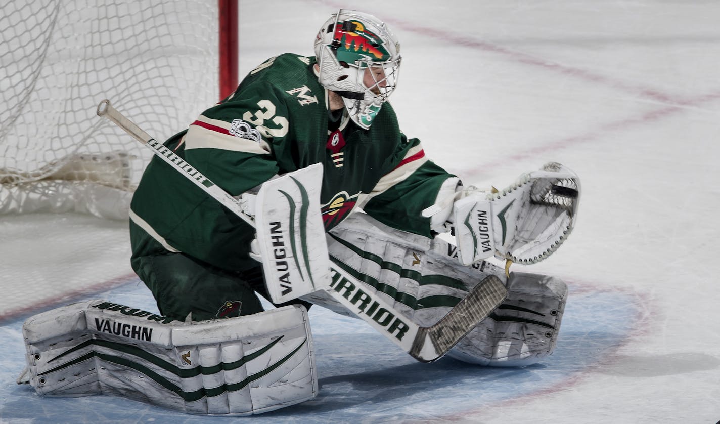 Alex Stalock (32) caught a shot by Matthew Tkachuk (19) during the overtime shootout. ] CARLOS GONZALEZ &#xef; cgonzalez@startribune.com - December 12, 2017, St. Paul, MN, Xcel Energy Center, NHL, Hockey, Minnesota Wild vs. Calgary Flames