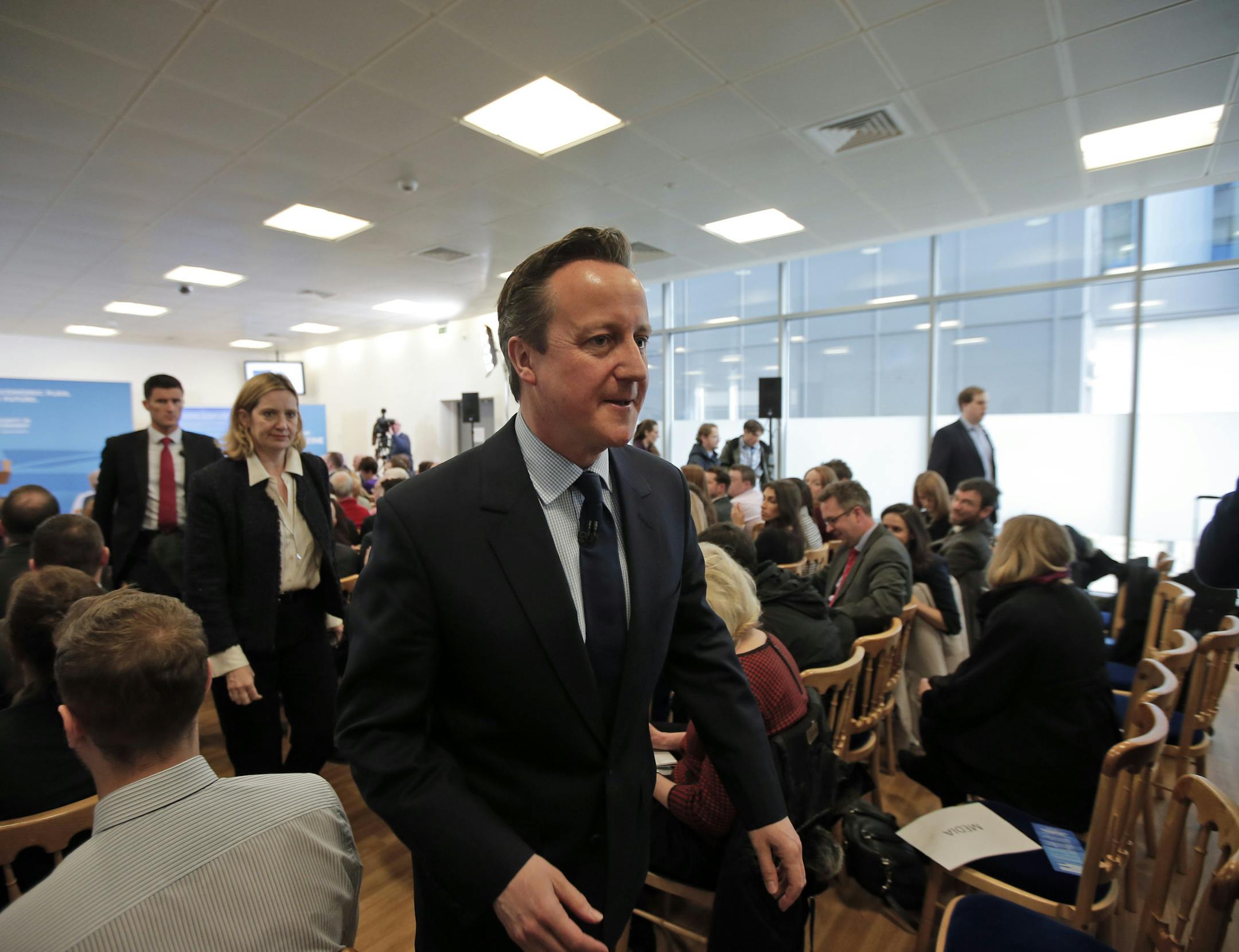 Britain's Prime Minister David Cameron, foreground leaves after delivering a speech about retirement, as he sets out the Conservative Party's fifth manifesto theme, in Hastings, south England, Monday, Feb. 23, 2015. (AP Photo/Lefteris Pitarakis)