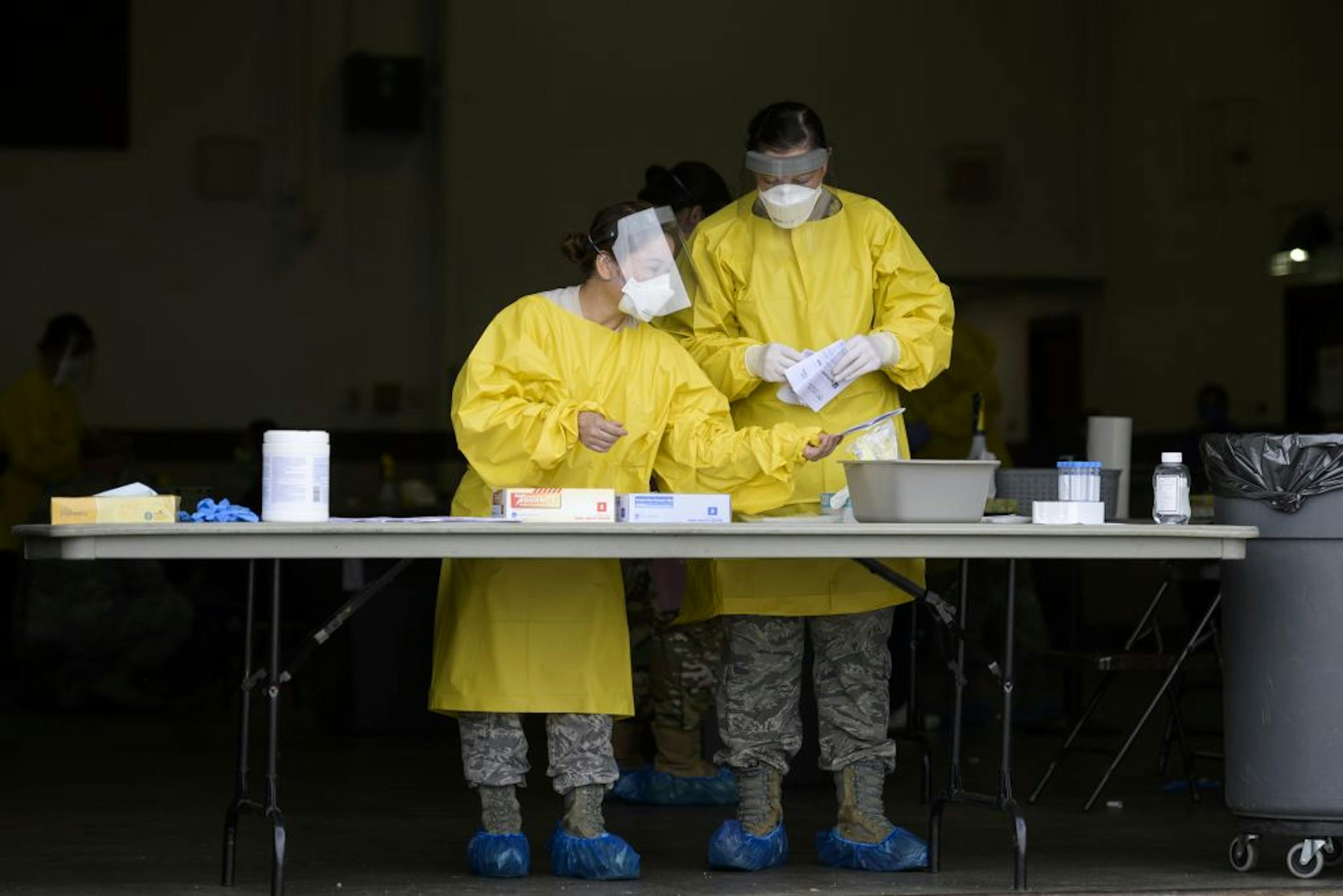 Elizabeth Santoro, left, and Kristin Anderson, medics with the Minnesota Air National Guard 133rd Medical Group, sanitized and prepared for their next COVID-19 test patients Saturday at the Minneapolis Armory.
