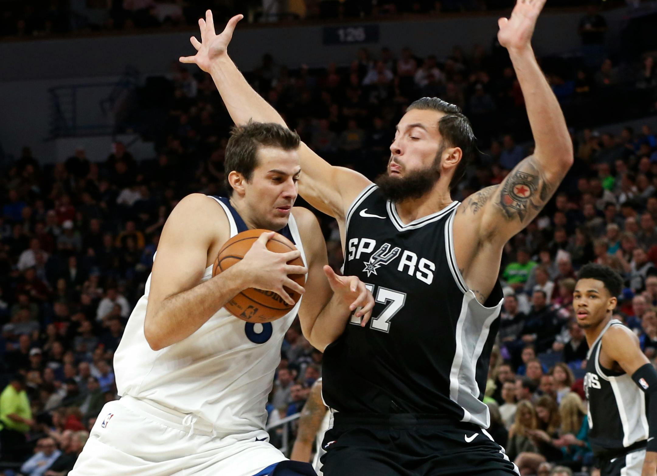 Minnesota Timberwolves' Nemanja Bjelica, left, bumps into San Antonio Spurs' Joffrey Lauvergne during the second half of an NBA basketball game Wednesday, Nov. 15, 2017, in Minneapolis. The Timberwolves won 98-86.. (AP Photo/Jim Mone)