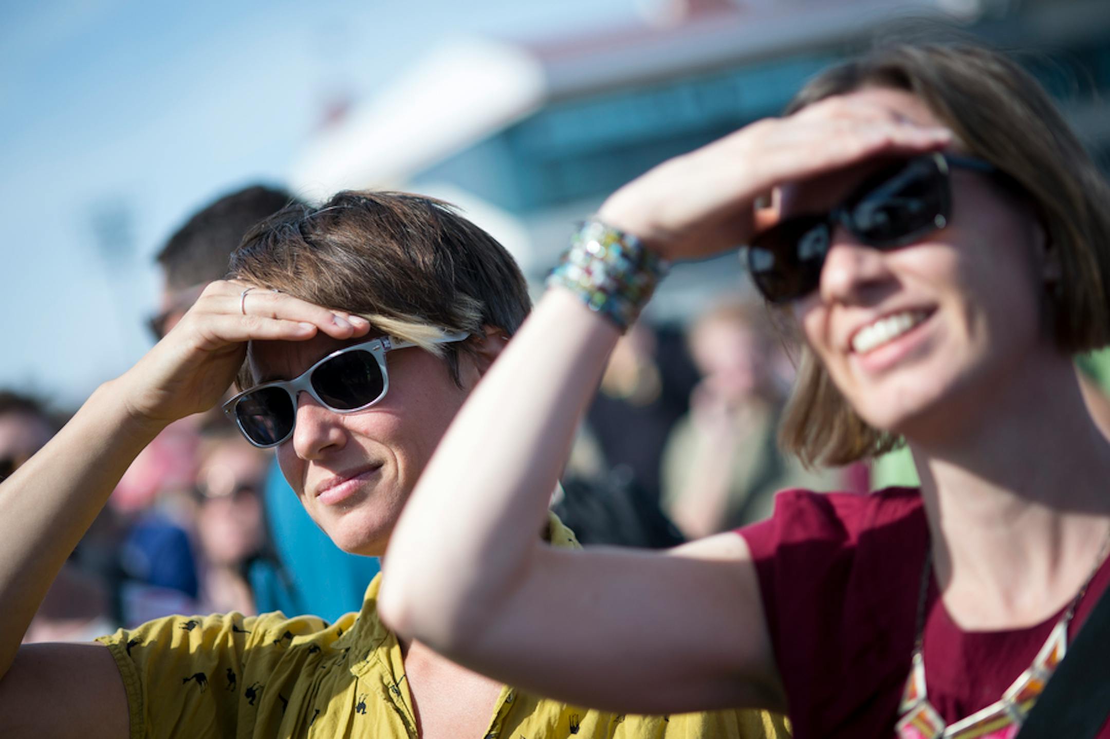 Elsa Bross, left, and Laura Willemsen shielded their eyes from the sun while watching performances at Festival Palomino Saturday.