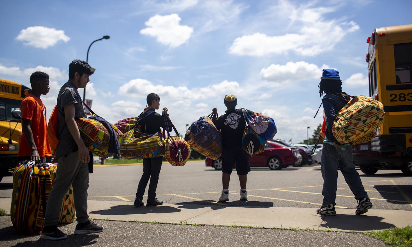 Christian Adeti's drumming students wait to put drums back in his car after practice. ] NICOLE NERI &#x2022; nicole.neri@startribune.com BACKGROUND INFORMATION: During an African drumming lesson through Trio Educational Talent Search at Hennepin Technical College in Brooklyn Park, MN Tuesday, July 2, 2019.