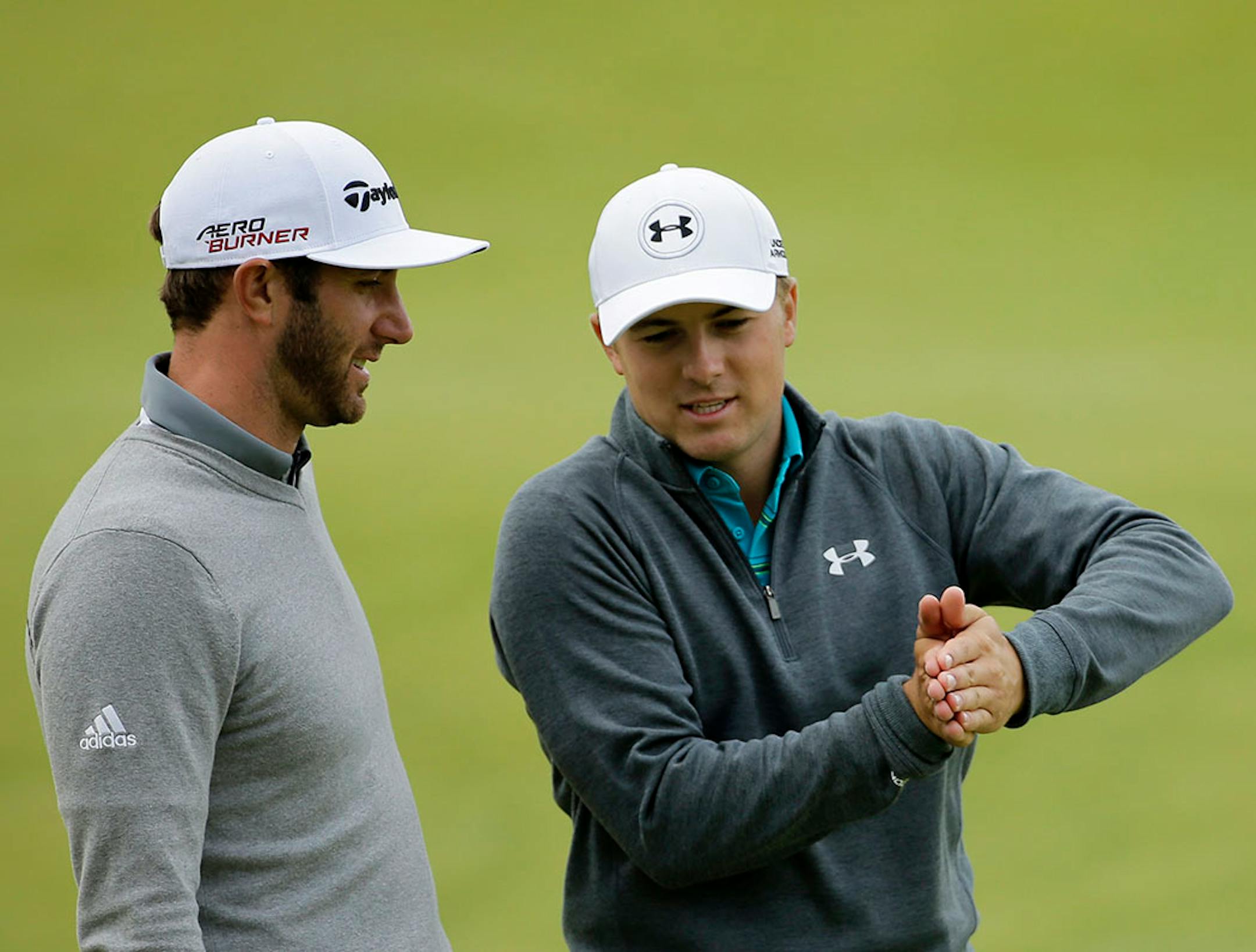 United States'Jordan Spieth, right, and United States' Dustin Johnson chat after finishing on the 18th green during the first round of the British Open Golf Championship at the Old Course, St. Andrews, Scotland, Thursday, July 16, 2015.