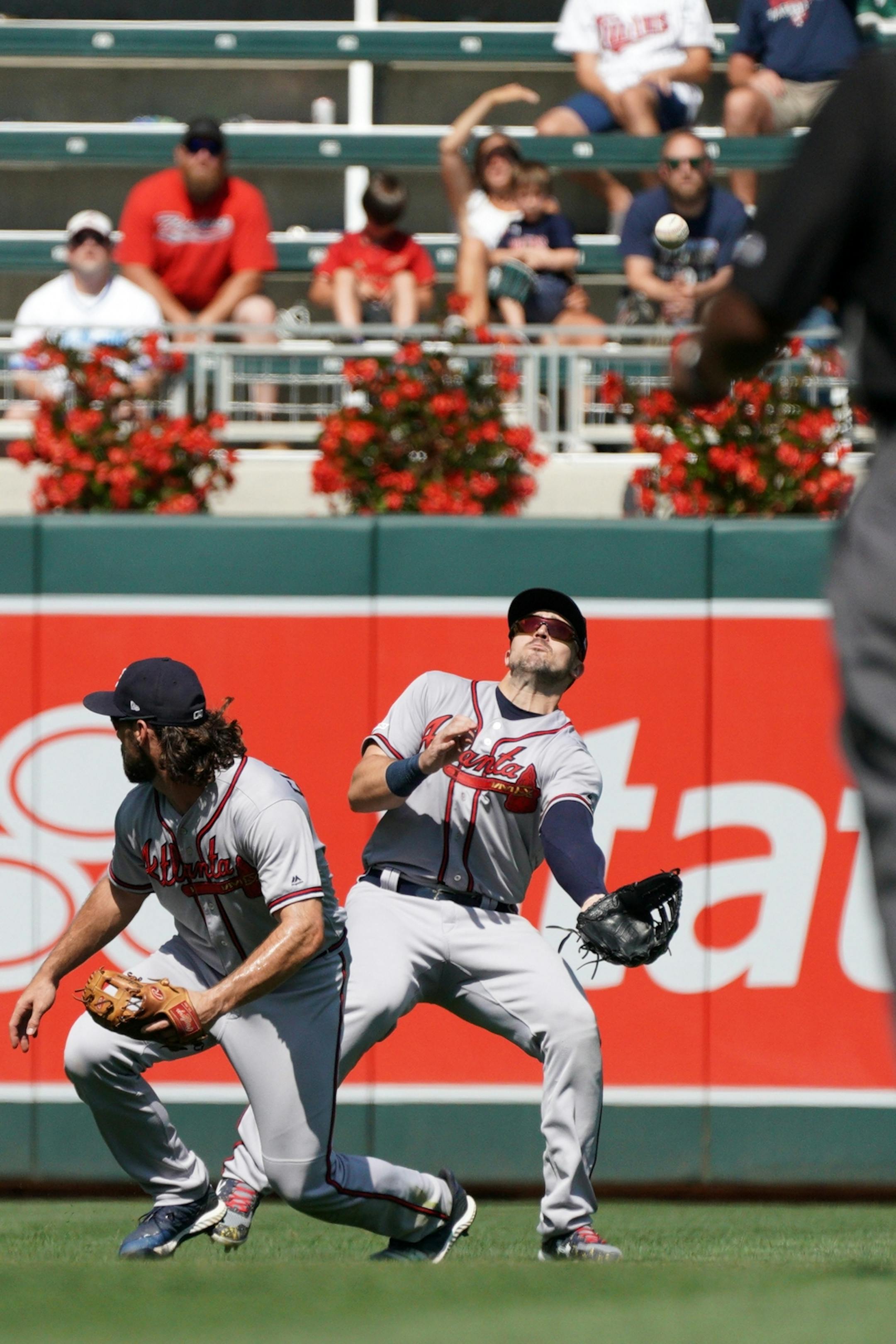 Atlanta Braves left fielder Adam Duvall (23) was unable to field a pop fly hit by Minnesota Twins shortstop Ehire Adrianza (13) for a base hit in the ninth inning.