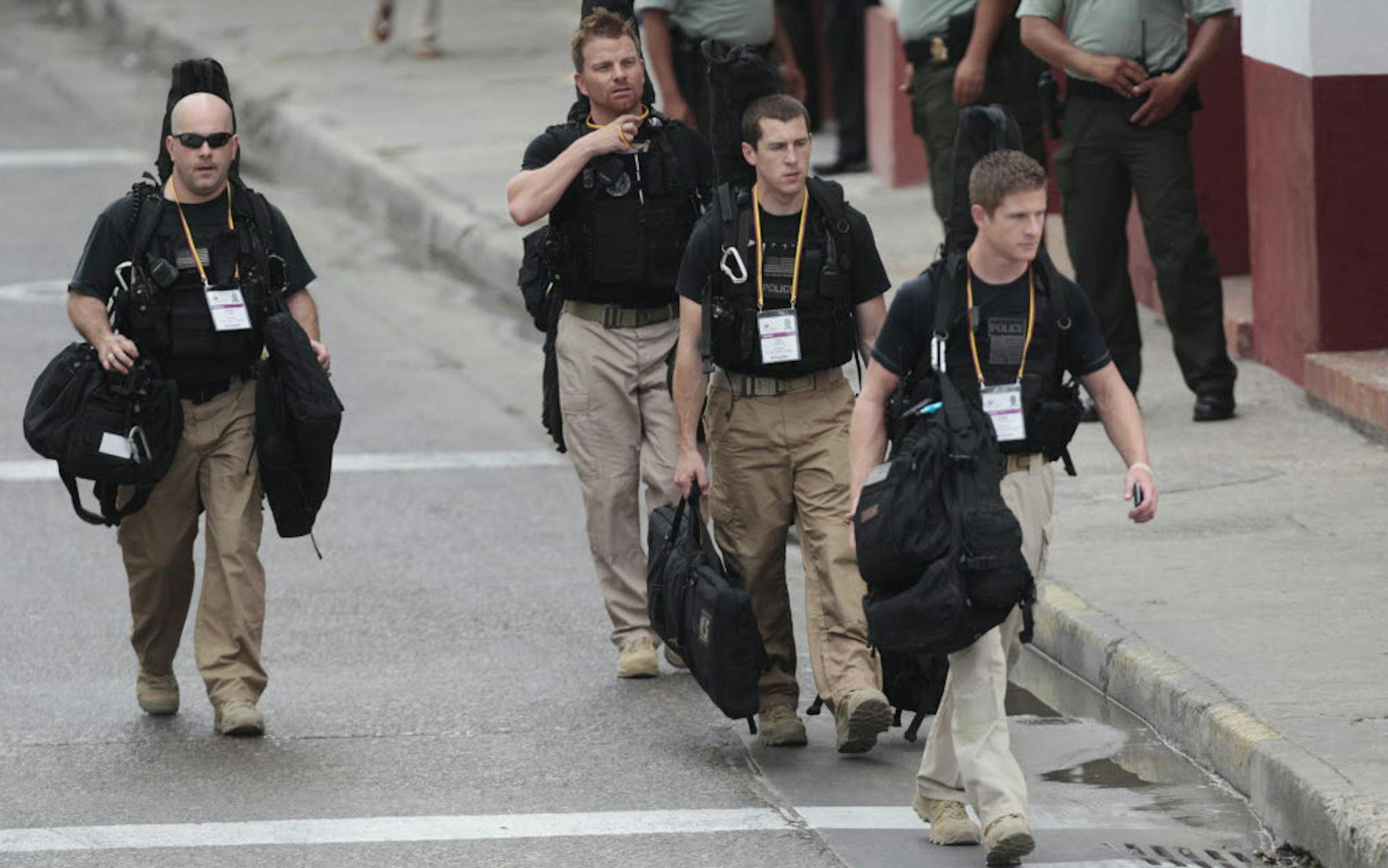 U.S. secret service agents walk around the Convention Center in Cartagena, Colombia, prior to the opening ceremony of the 6th Summit of the Americas.