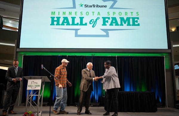 Former Minnesota Viking Scott Studwell, former Gopher and North Star Lou Nanne, and former Gopher hoops star Linda Roberts, from left, the three honor