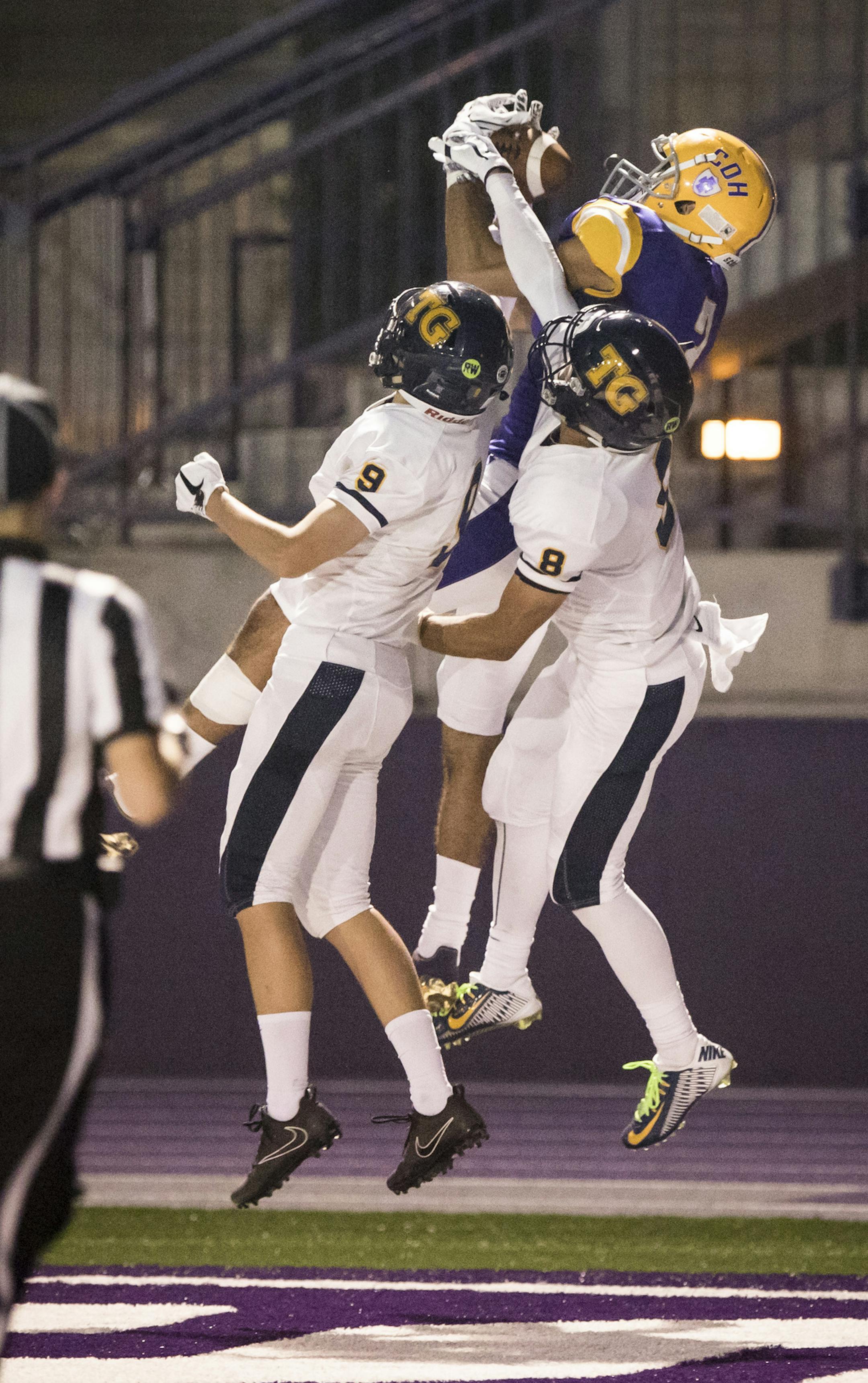 Cretin-Derham Hall's Peter Udoibok (3) caught a pass for a touchdown against Totino-Grace's Sam Quick (9) and Ryan Suggs (8) during the first half of a Totino-Grace verse Cretin-Derham Hall football game at O'Shaughnessy Stadium at the University of St. Thomas on Thursday, August 31, 2017, in St. Paul, Minn. ] RENEE JONES SCHNEIDER • renee.jones@startribune.com