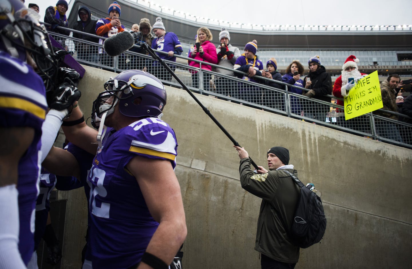 Ryan Cardinal, right, used a boom microphone to capture a huddle as players emerged onto the field at TCF Bank Stadium last month.