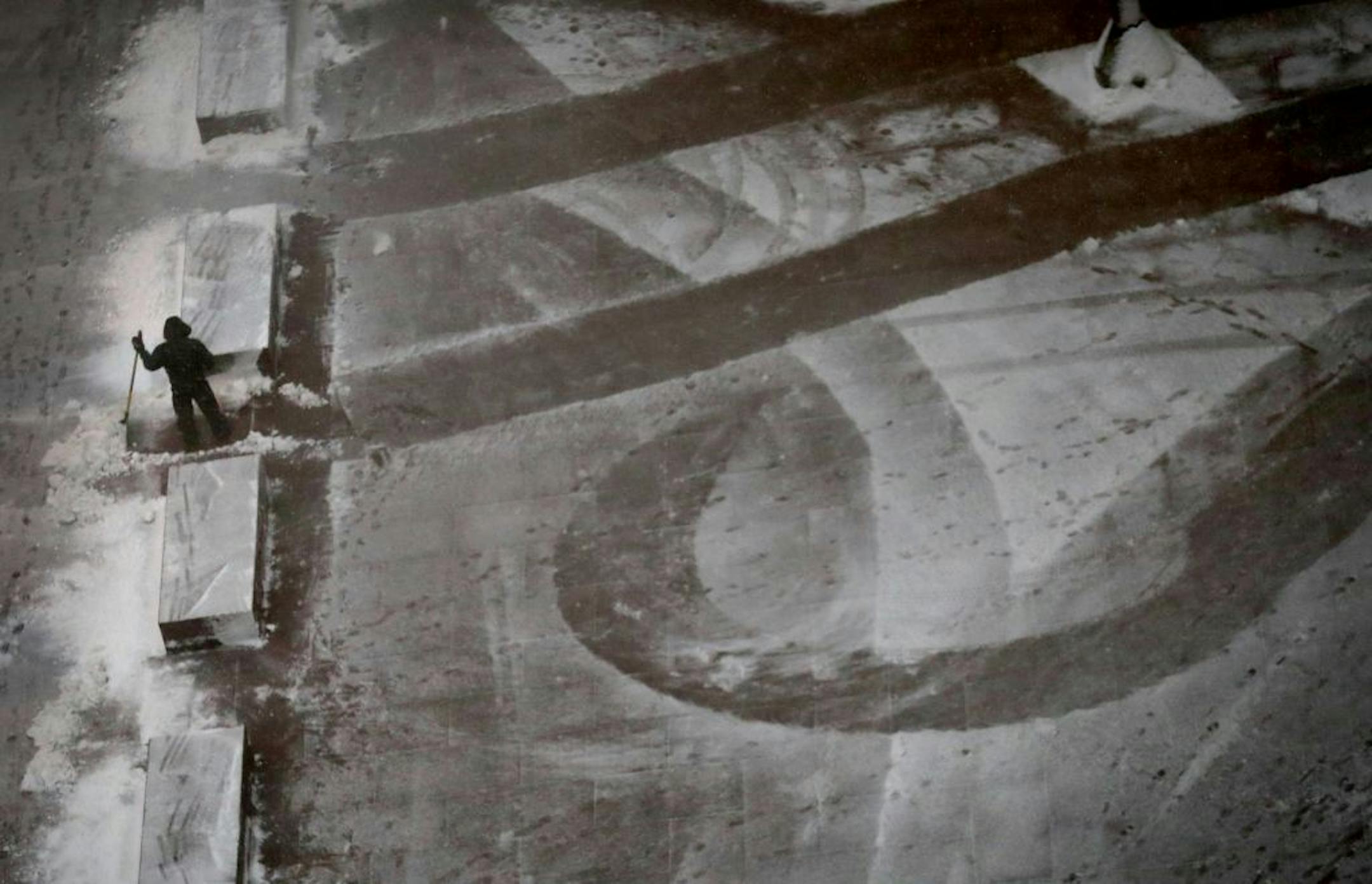 A maintenance person pauses from the task of snow removal outside the US Bank Plaza Tuesday, March 6, 2018, in Minneapolis, MN.