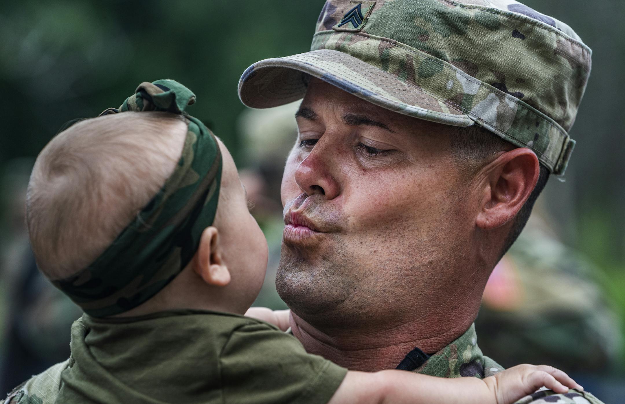 Sgt. Shawn Blakemore blew kisses to his 6-month-old daughter Liv. Blakemore and the rest of the 34th Military Company are deploying to Guantanamo Bay.