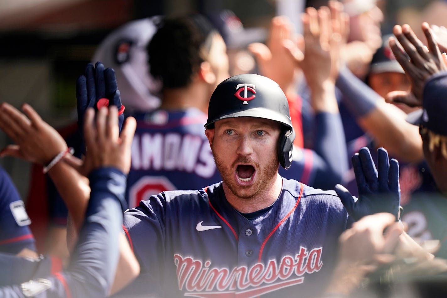 Minnesota Twins' Kyle Garlick celebrates with teammates after he hit a three-run home run in the tenth inning of a baseball game against the Cleveland Indians, Sunday, May 23, 2021, in Cleveland. (AP Photo/Tony Dejak)