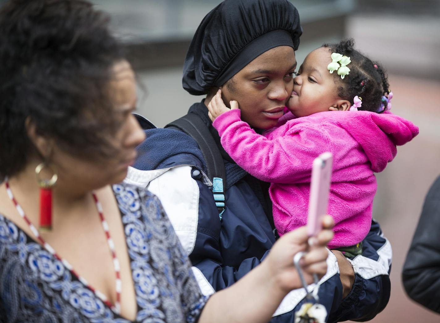 Plaintiff Shyntoria Johnson and her daughter Yunique, 1, gather outside the Hennepin County Courthouse during a press conference announcing a lawsuit against the state of Minnesota for allowing segregation in schools in downtown Minneapolis on Thursday, November 5, 2015. ] (LEILA NAVIDI/STAR TRIBUNE) leila.navidi@startribune.com BACKGROUND INFORMATION: Seven families are suing the state of Minnesota for allowing segregation of public schools and depriving families of an equitable education.