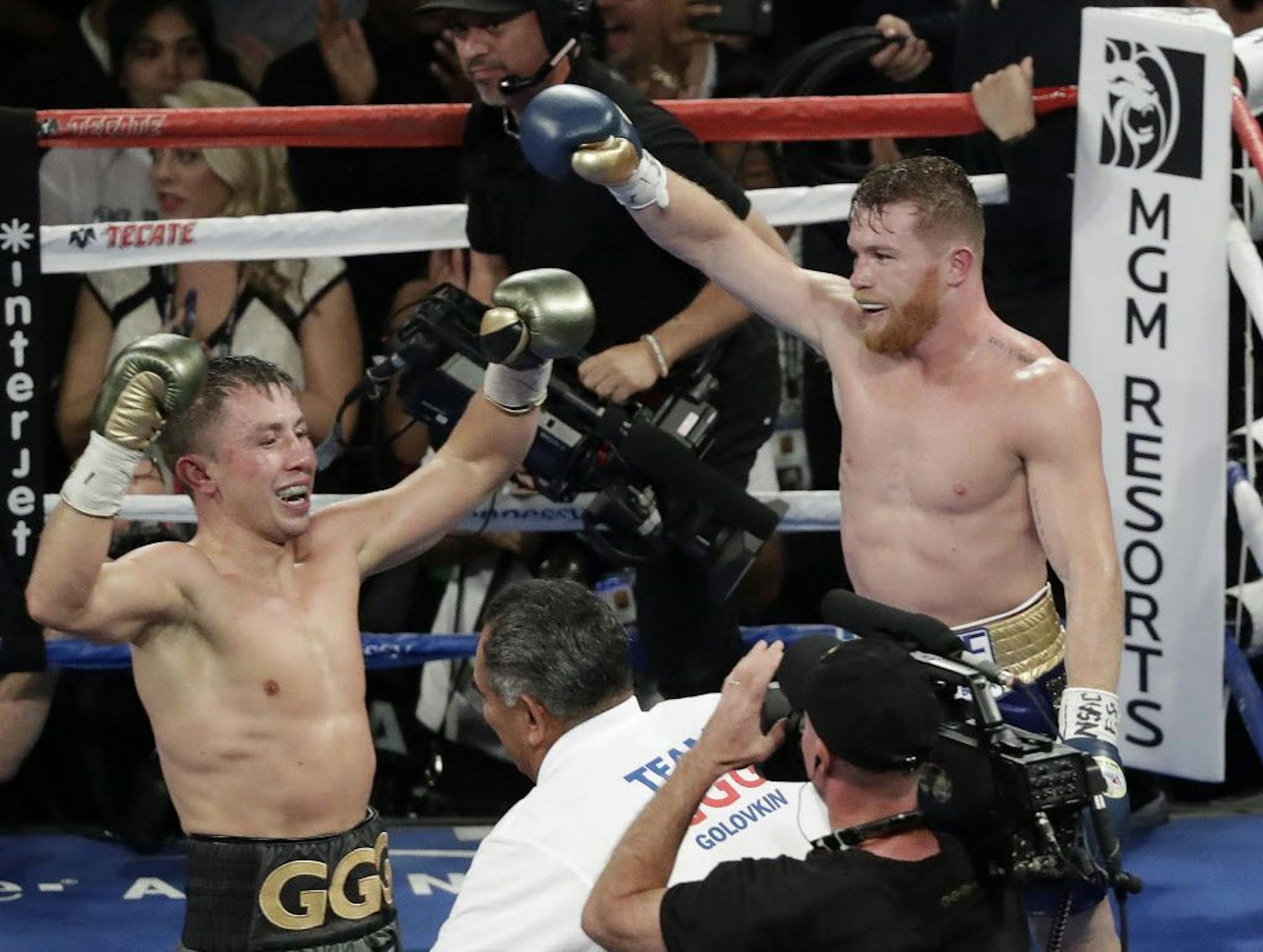 Canelo Alvarez, right, and Gennady Golovkin celebrate following a middleweight title fight Sunday, Sept. 17, 2017, in Las Vegas. The fight was called a draw.