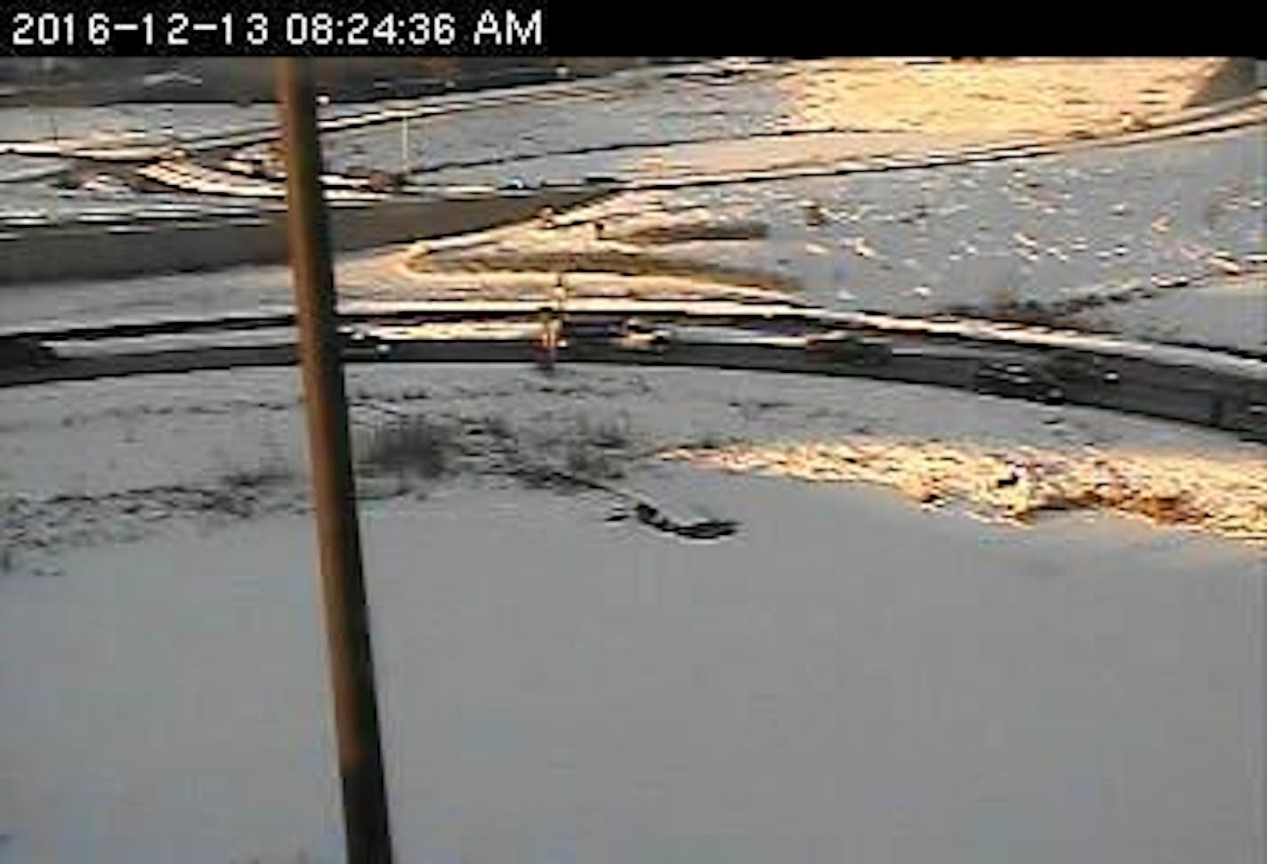 A Minnesota Department of Transportation camera shows a woman being pulled to safety after her vehicle plunged into a holding pond.