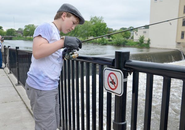 Cully Hauck, 13, of Northfields, tries his luck fishing at Bridge Square. Hauck said he and other boys in the area asked a city worker if they could k