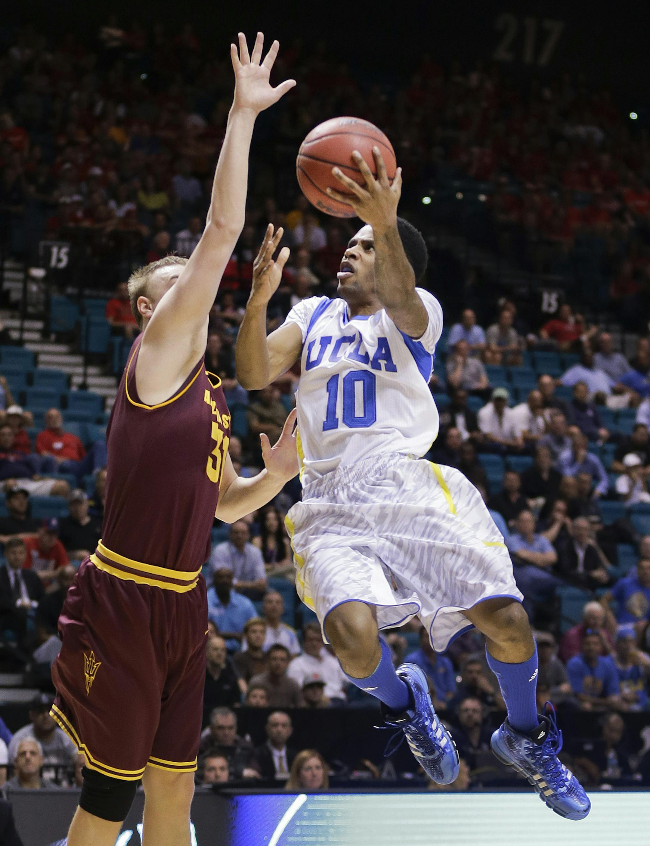 UCLA's Larry Drew II (10) goes up for a shot against Arizona State's Jonathan Gilling during the first half of a Pac-12 men's tournament NCAA college basketball game, Thursday, March 14, 2013, in Las Vegas. (AP Photo/Julie Jacobson) ORG XMIT: MIN2013032116142679