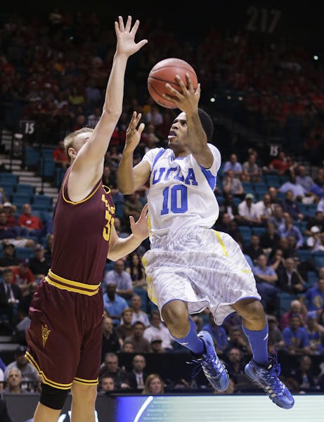 UCLA's Larry Drew II (10) goes up for a shot against Arizona State's Jonathan Gilling during the first half of a Pac-12 men's tournament NCAA college 