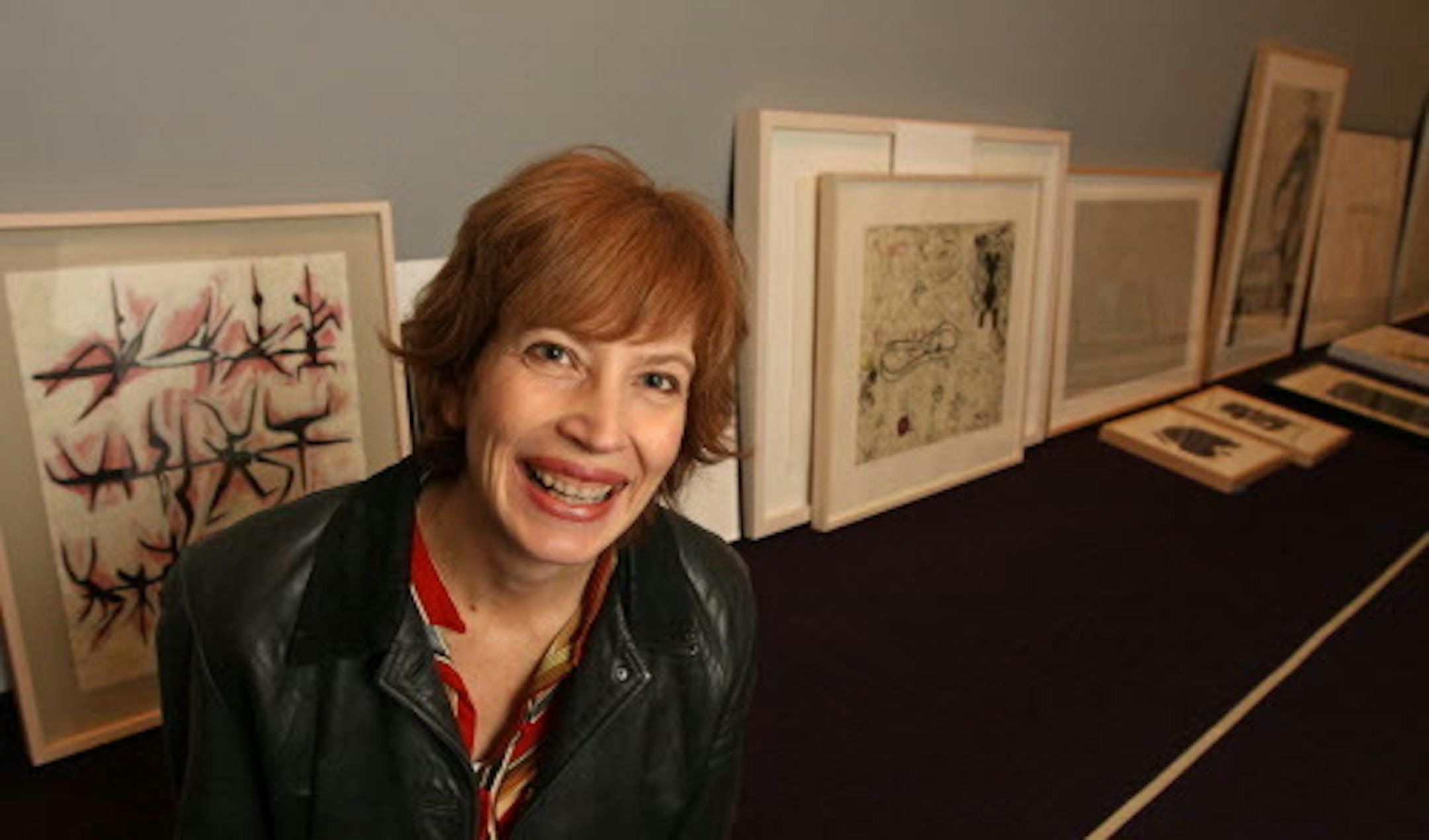 BRUCE BISPING • bbisping@startribune.com Minneapolis, MN., Friday, 12/10/10]  (left to right)  Darsie Alexander, Walker Art Center Curator for the "50/50" show arranged works on the floor before hanging.  The show features works that were half picked by public votes and half by Alexander.