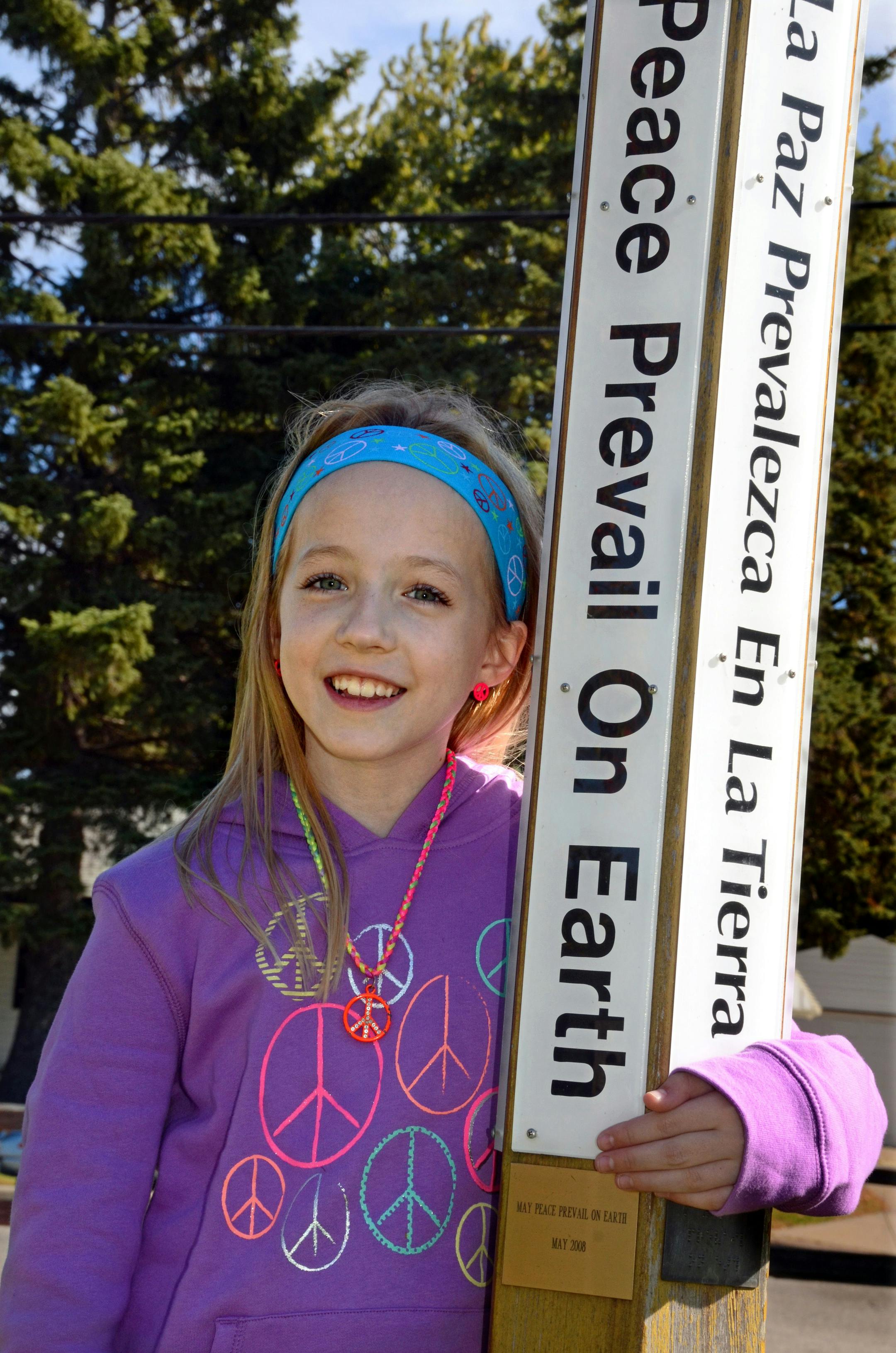 Jaelyn Lende, a third grader at Cowern Elementary School in North St.Paul, stood next to the peace pole at the school. Cowern Elementary School is an International Peace Site. ] Joey McLeister,Special to the Star Tribune,North St. Paul,MN October14,2014