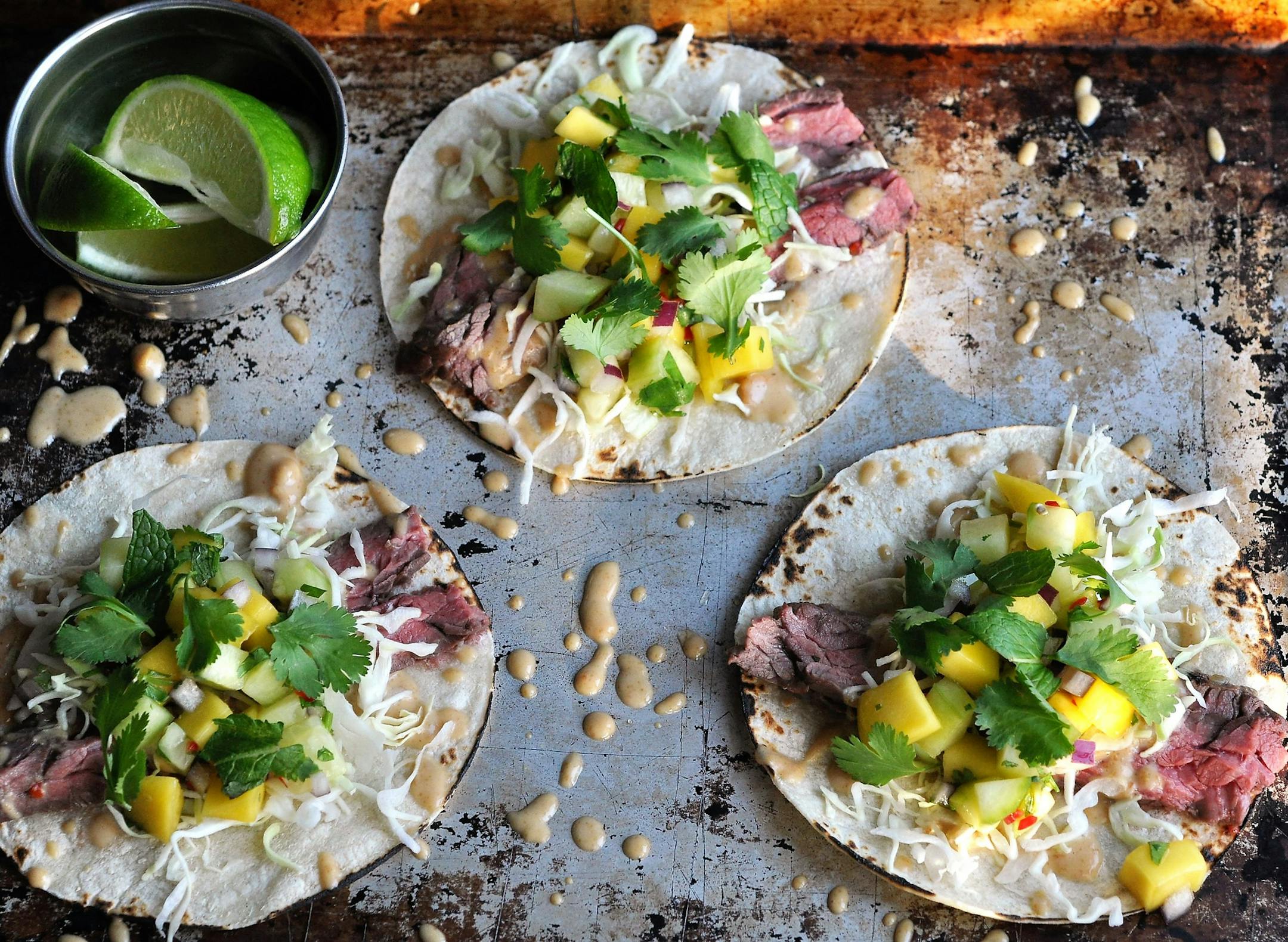Thai Skirt Steak Tacos With Peanut Sauce and Cucumber-Mango Salsa.