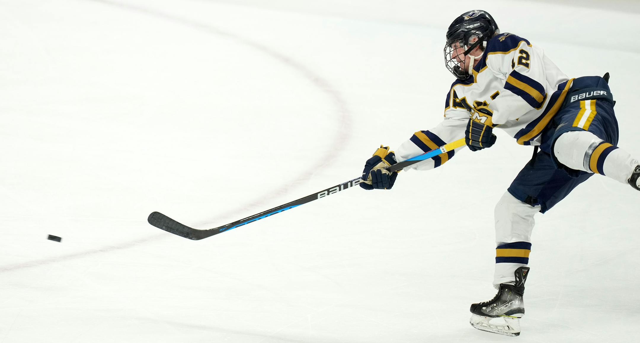 Hermantown defenseman Nolan Barker (12) takes a shot in the first period of a MSHSL Class 1A quarterfinal hockey game between Luverne and Hermantown.