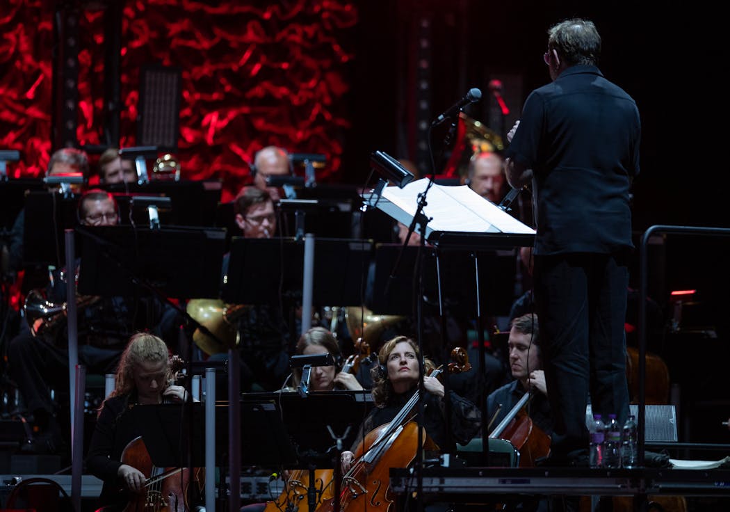 An orchestra backing the Who at Xcel Energy Center in 2019 included cellist Rebecca Arons on cello, center.