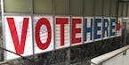 A "Vote Here" sign marks the entrance on Thursday, Sept. 20, 2018, to an early voting station in downtown Minneapolis for Friday's opening of early vo