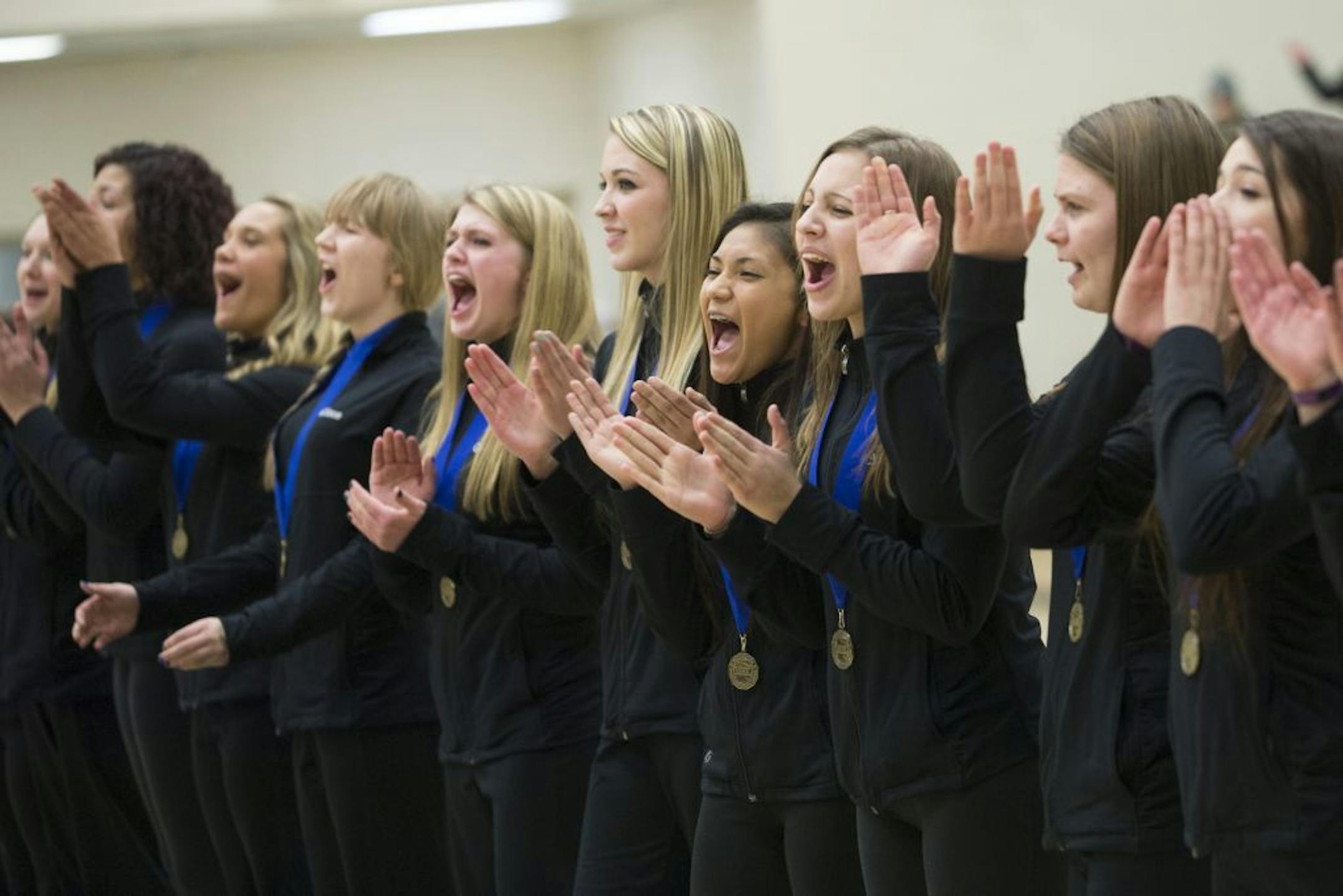 The Fairbault high kick dance team, the Emeralds, cheer on the Cannon Falls team, the only team to support them after their controversial win at State during a rally in support of the Emeralds on Tuesday night at Fairbault High School.