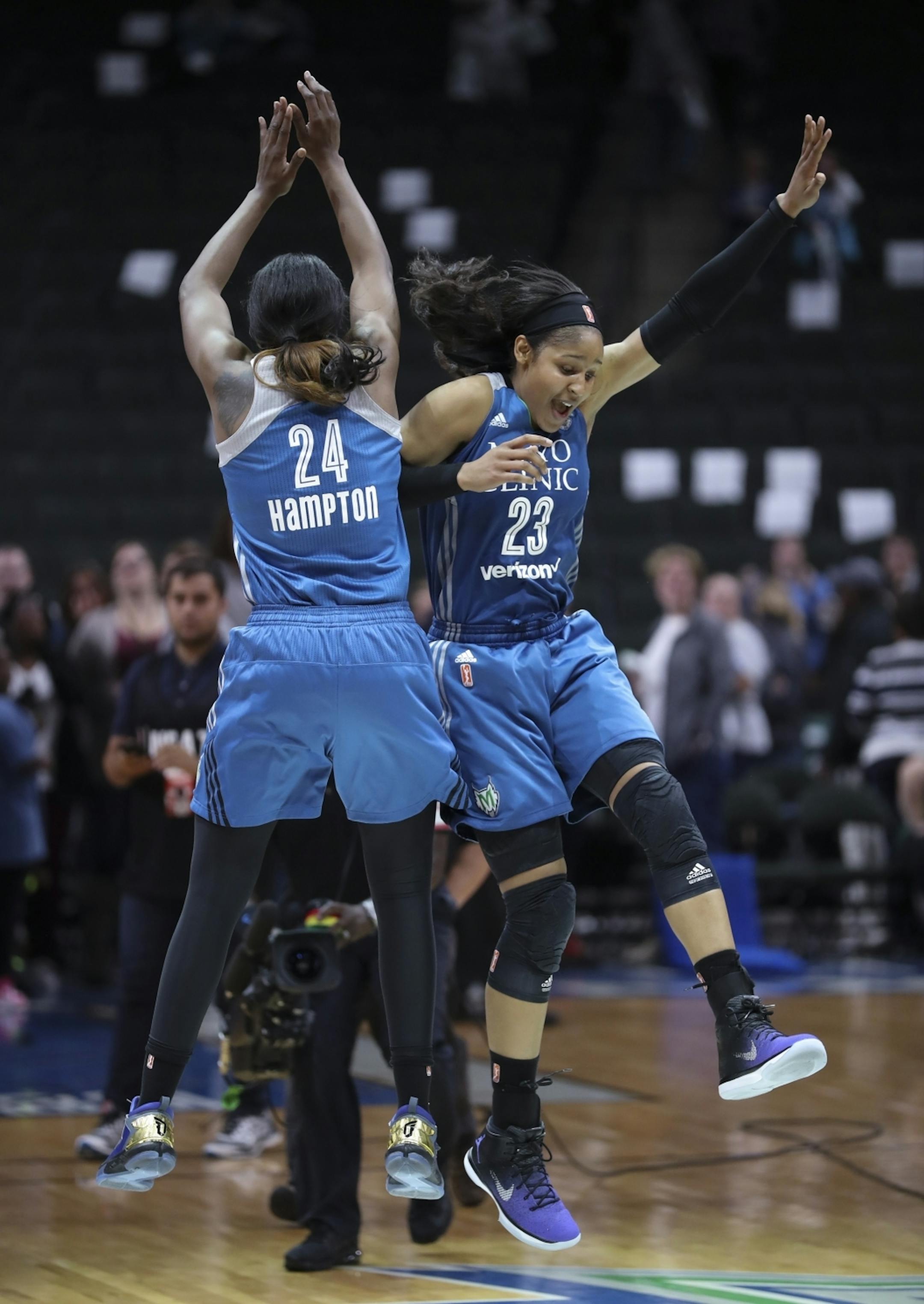 Minnesota Lynx forward Maya Moore (23) and teammate Keisha Hampton (24) celebrated the playoff win at center court.