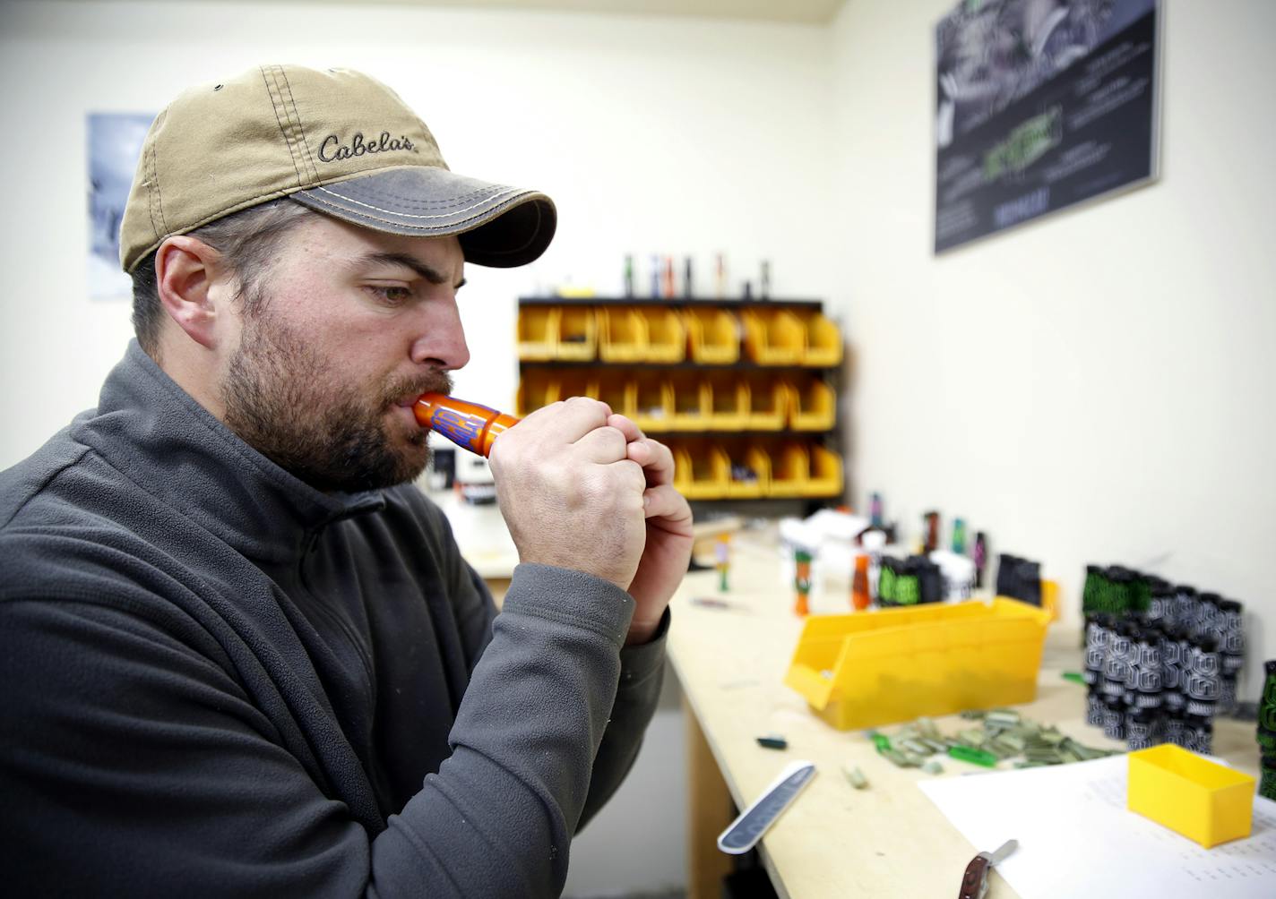 Scott Threinen tests a goose call in the headquarters of Molt Gear in Rochester, Minn. ] LEILA NAVIDI leila.navidi@startribune.com / BACKGROUND INFORMATION: Wednesday, November 12, 2014. Scott Threinen is a three-time champion goose caller and the founder of Molt Gear, a business catering to waterfowl hunters out of Rochester, Minn.