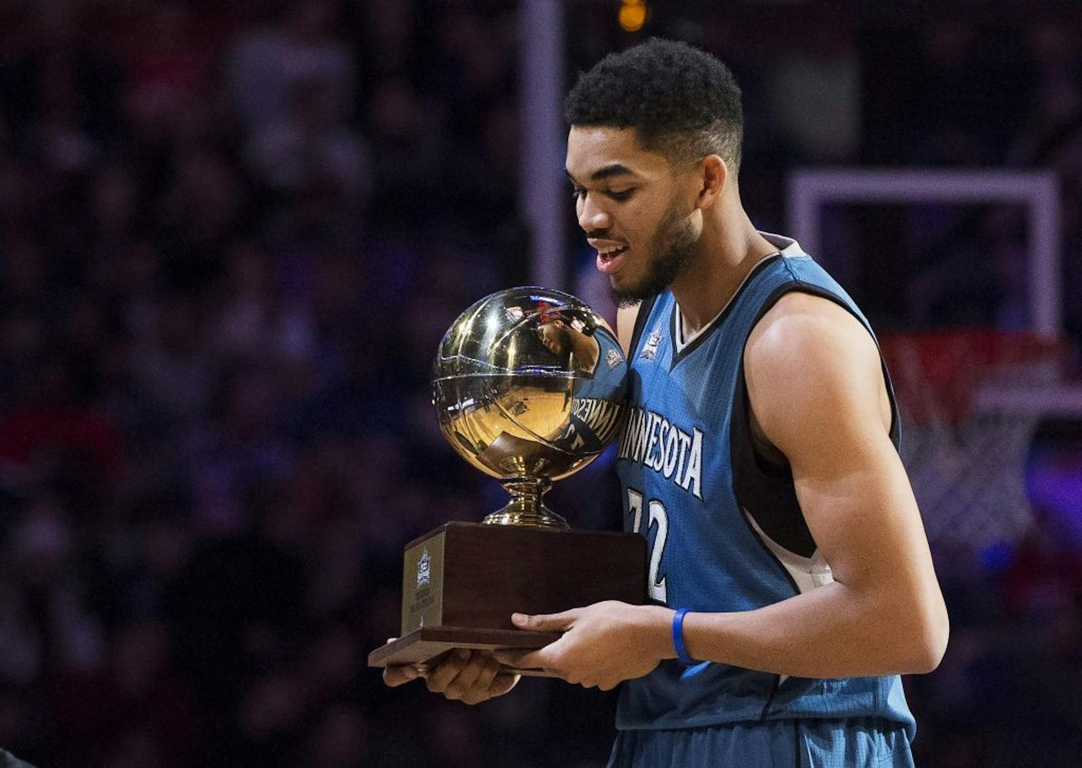 Minnesota Timberwolves' Karl-Anthony Towns (32) hold the trophy after winning the front court NBA all-star skills competition in Toronto on Saturday, Feb. 13, 2016. (Mark Blinch/The Canadian Press via AP) MANDATORY CREDIT