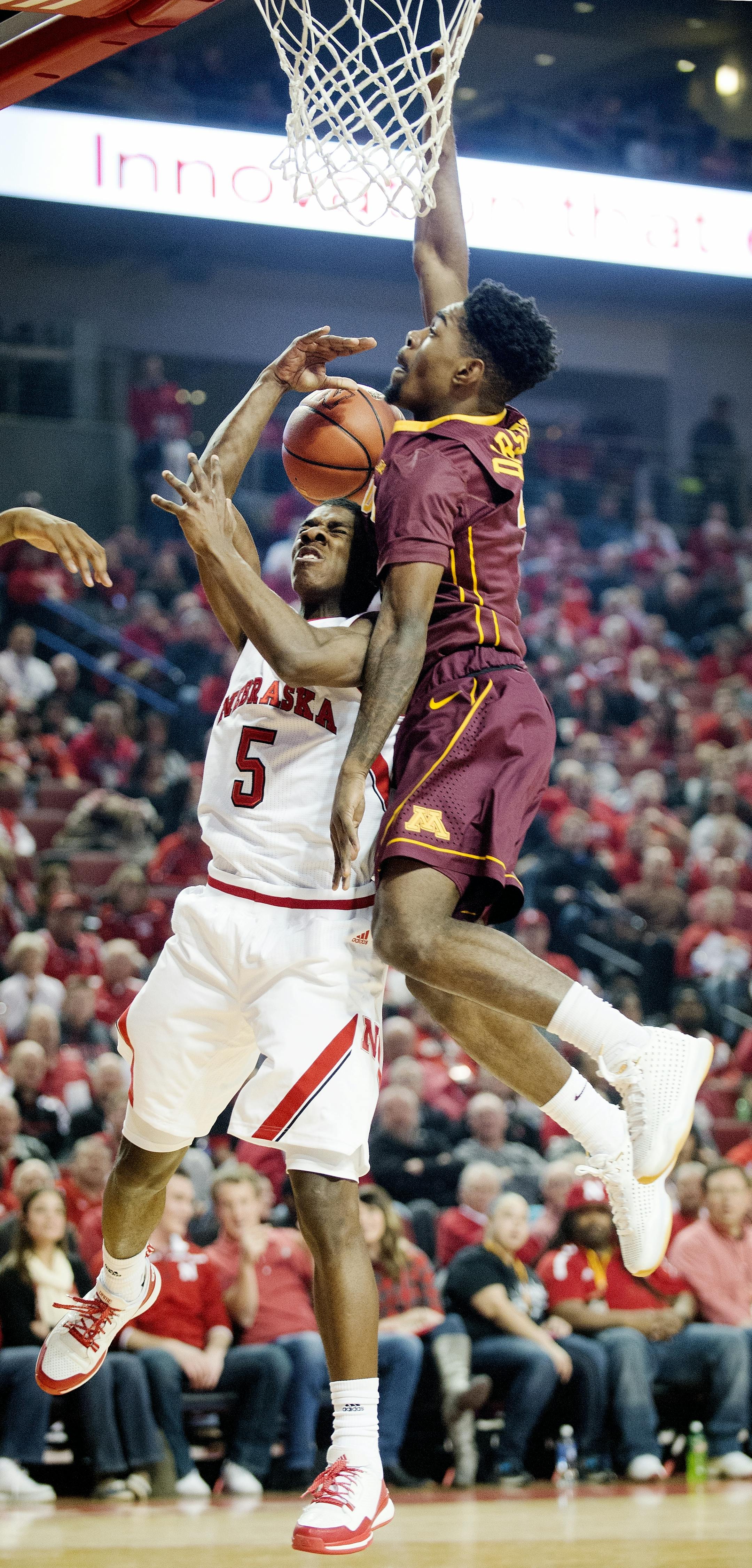Nebraska guard Glynn Watson Jr. (5) gets fouled by Minnesota guard Kevin Dorsey (4) during the first half of an NCAA college basketball game in Lincoln, Neb., Tuesday, Jan. 12, 2016. (Francis Gardler/The Journal-Star via AP) LOCAL TELEVISION OUT; KOLN-TV OUT; KGIN-TV OUT; KLKN-TV OUT; MANDATORY CREDIT