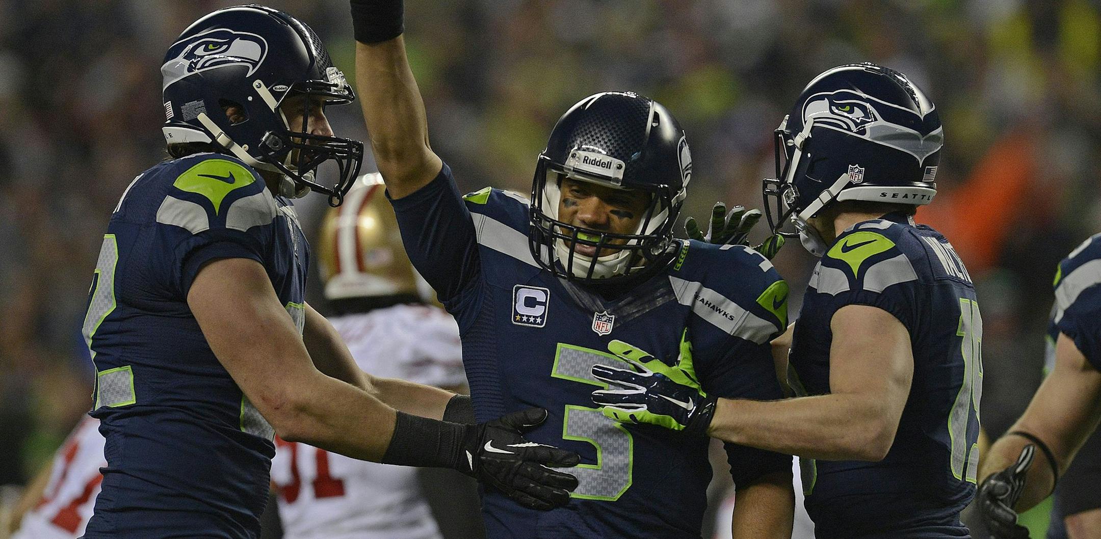 Seattle Seahawks quarterback Russell Wilson (3) raises his arm in celebration after defeating the San Francisco 49ers in their NFC championship game at CenturyLink Field in Seattle on Sunday, Jan. 19, 2014. The Seattle Seahawks defeated the San Francisco 49ers, 23-17. (Jose Carlos Fajardo/Bay Area News Group/MCT) ORG XMIT: 1148053