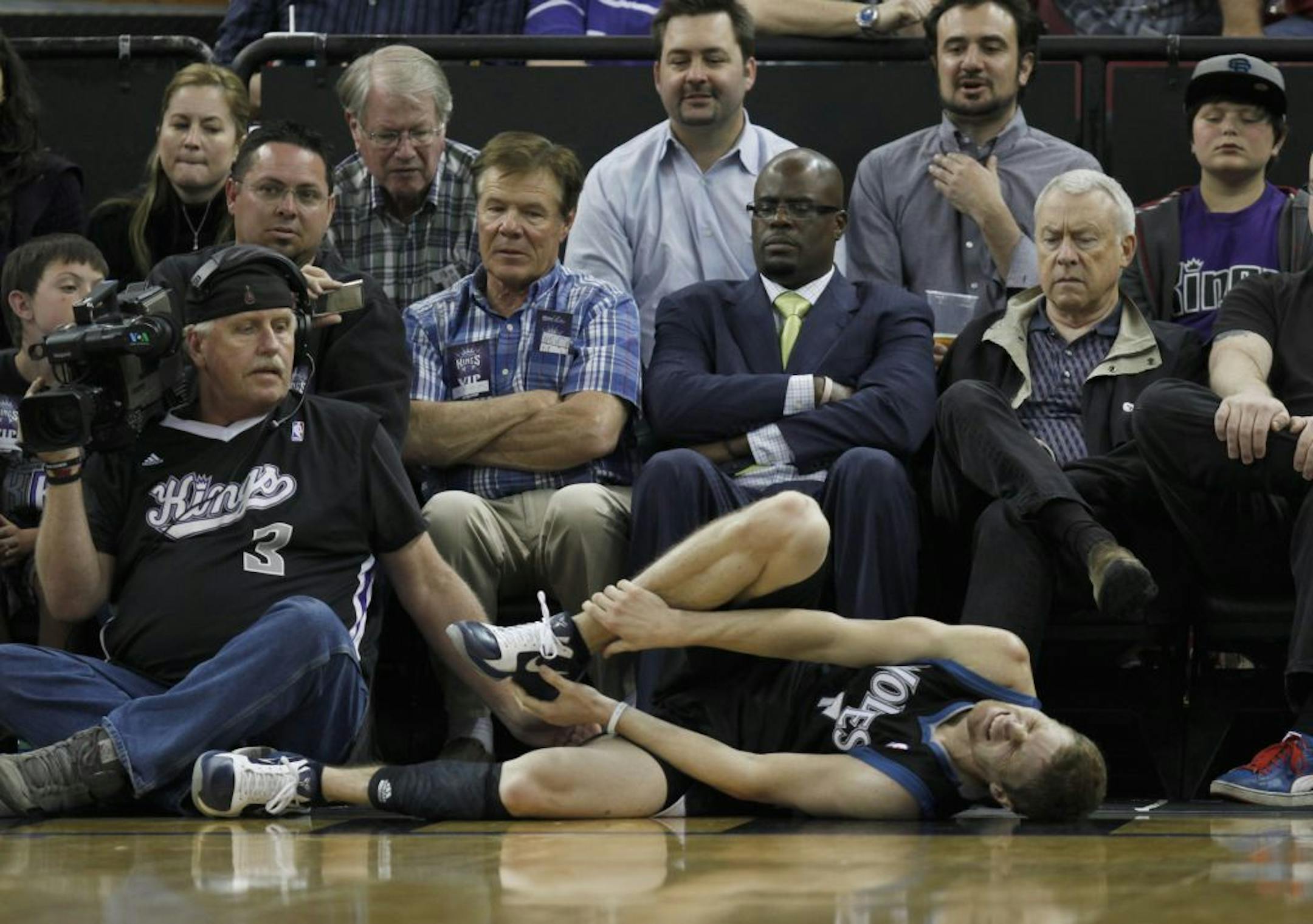 Timberwolves point guard Luke Ridnour clutched his right leg in pain after suffering an ankle injury at Sacramento.