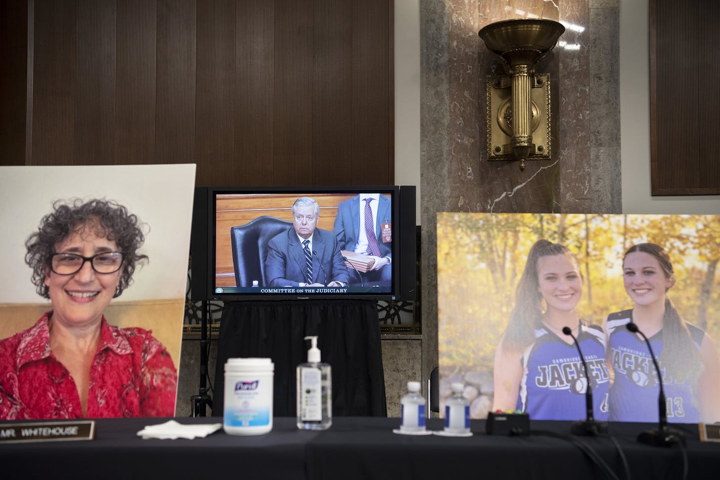 Images of people who've been helped by the Affordable Care Act occupy the seats of Democratic Senators during a Senate Judiciary Committee Executive Business meeting last week.