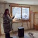 Duluth resident Becky Haase discusses the damage to her home’s basement following a February water main break, as her cat, Paisley, walks by.