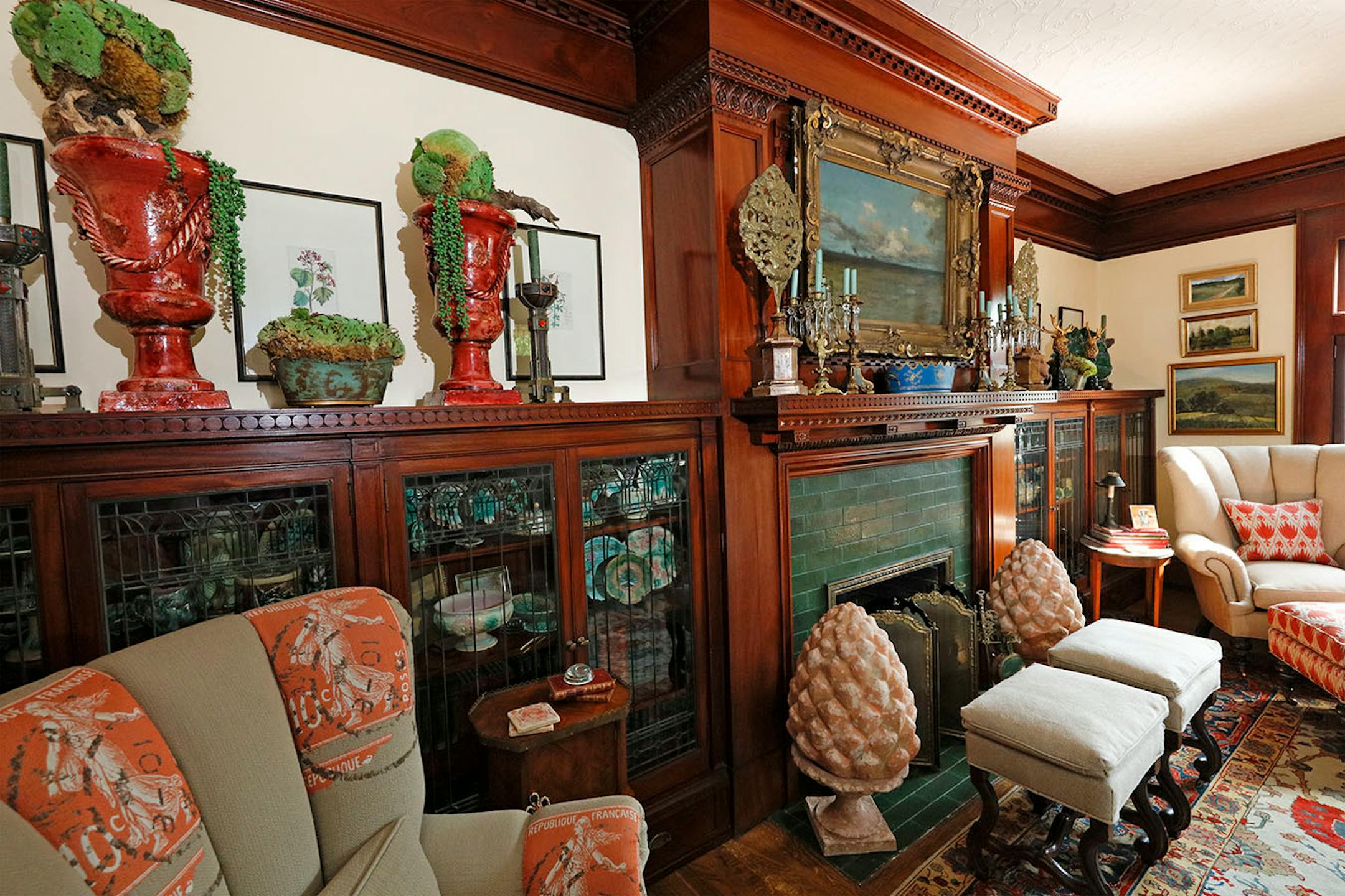 The formal living room still has its original fireplace flanked by built-in bookcases with leaded-glass doors.