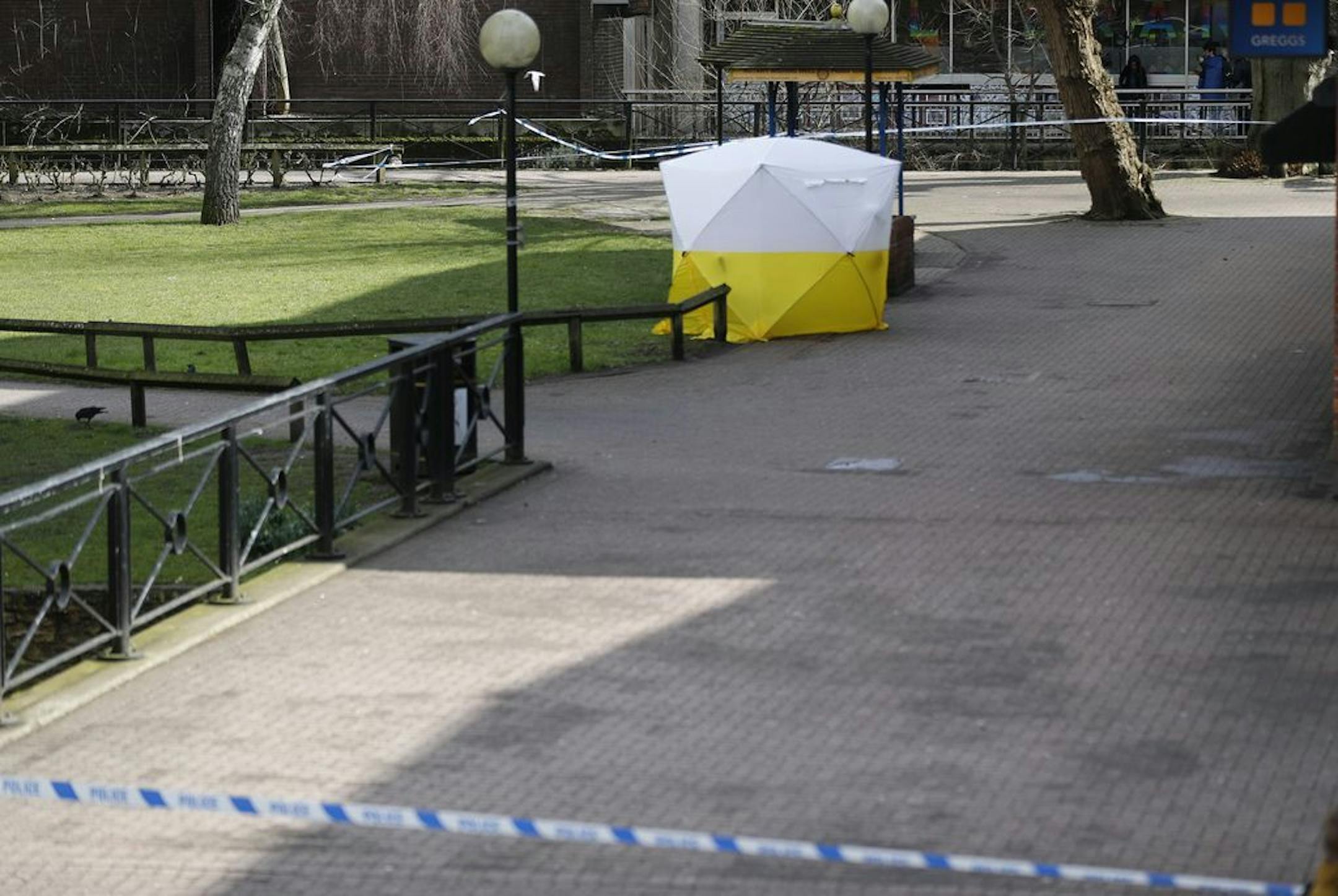 A police tent covers the the spot where former Russian double agent Sergei Skripal and his companion were found critically ill Sunday following exposure to an "unknown substance" in Salisbury, England, Tuesday, March 6, 2018. 66-year old Skripal, and unidentified woman companion are being treated in hospital, after they were found unconscious on the park bench.