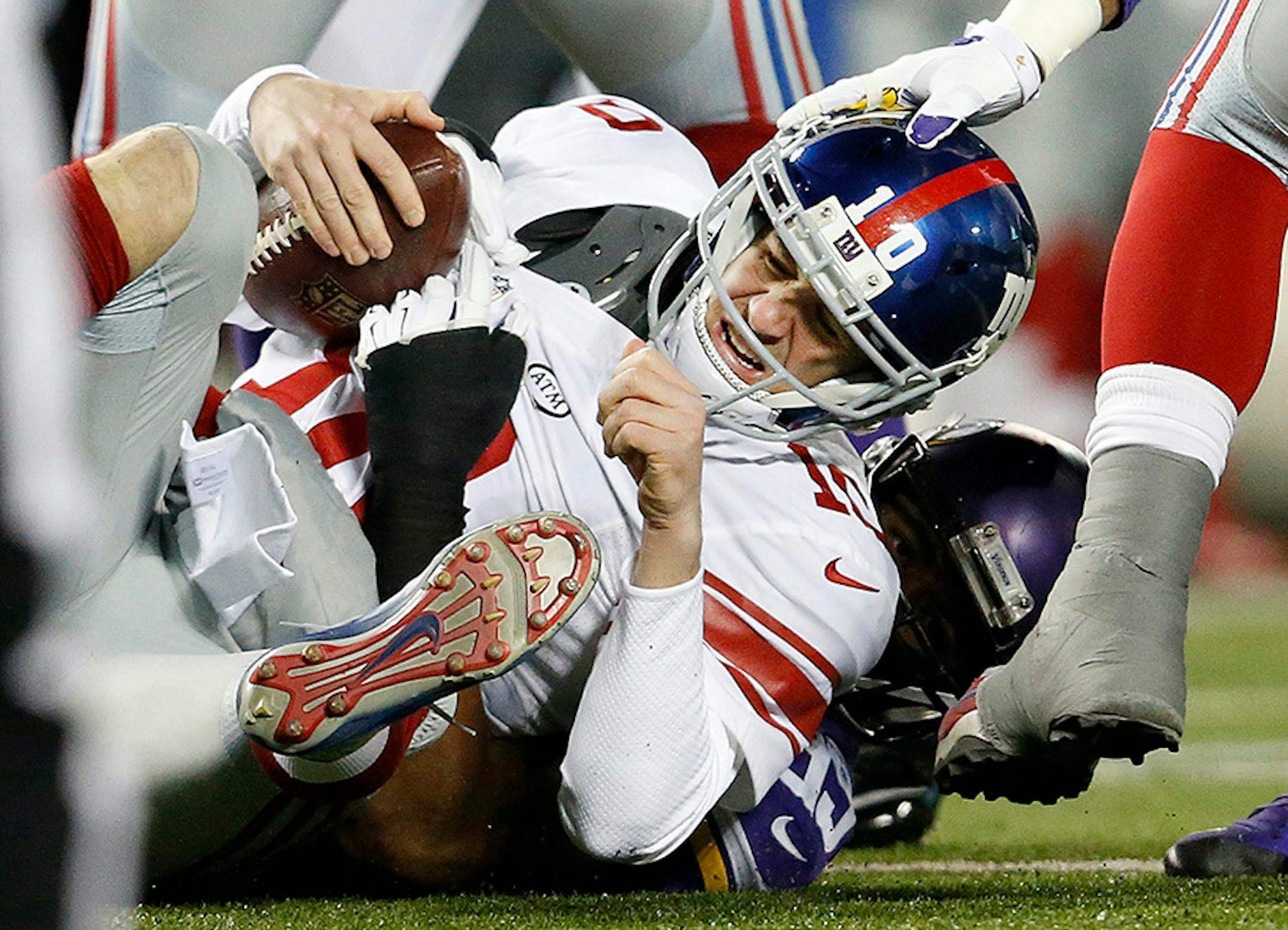 Eli Manning (10) was sacked by Danielle Hunter (99) in the first quarter.
