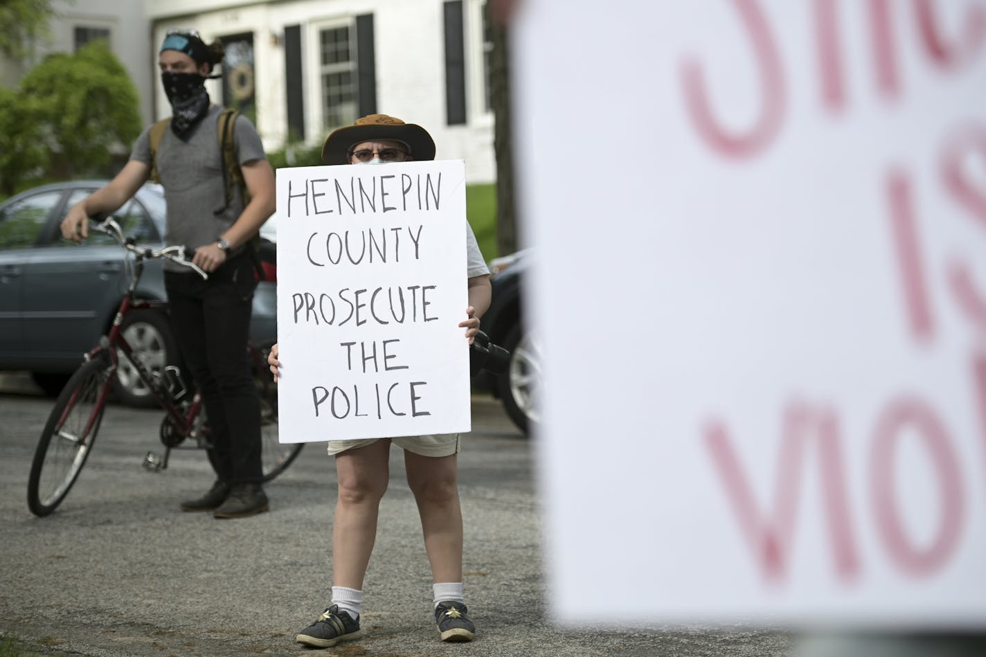 Kim DeFranco, of St. Paul, protested outside Hennepin County Attorney Mike Freeman's home Wednesday.