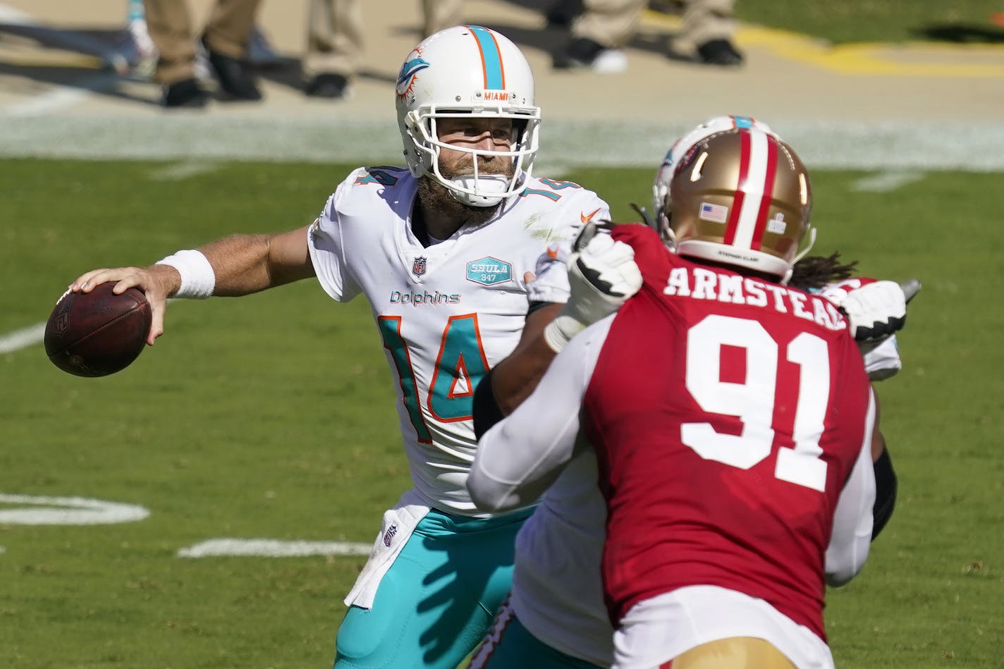 Miami Dolphins quarterback Ryan Fitzpatrick (14) passes as San Francisco 49ers defensive end Arik Armstead (91) applies pressure during the first half of an NFL football game in Santa Clara, Calif., Sunday, Oct. 11, 2020. (AP Photo/Tony Avelar)