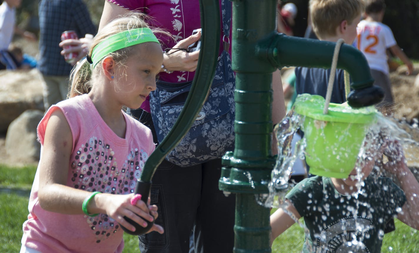 Isabel Aalberg, from Rosemount, tried out the handle water pump in the Nature Play area. Saturday was the opening day for the Whitetail Woods regional park. ] Isabel there with dad Jesse Aalberg. The first major new park in 30 years opens this weekend in a Dakota County that is eager to stem the heavy flow of parks users across their borders and into the celebrated systems in the central cities. Whitetail Woods, at 456 acres, is unique in the state and perhaps the nation because its an off-the-s