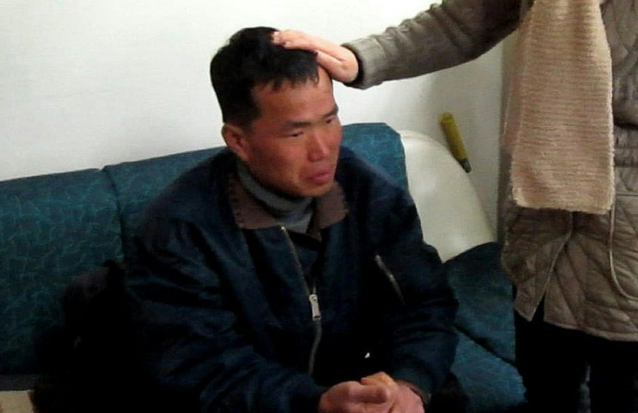 In this Jan. 24, 2014 image taken from a video footage released by Guro Police, Kim Seong-baek, left, meets with his mother, not identified her name, after he was rescued from a salt farm, at Guro Police Station in Seoul, South Korea.
