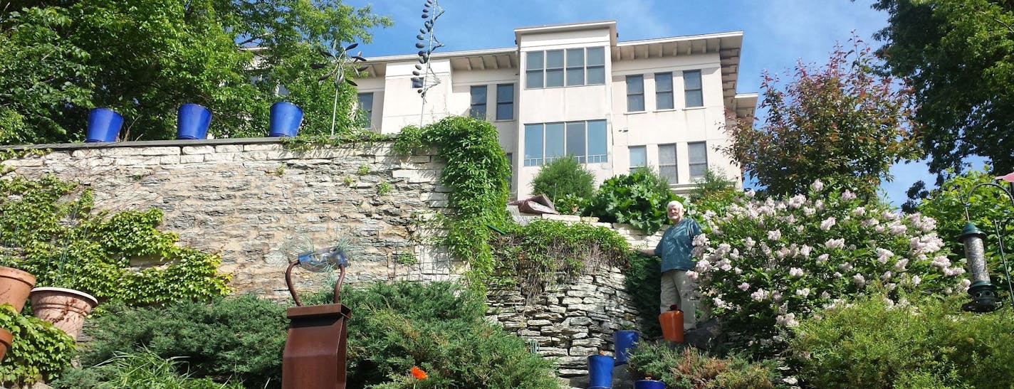 Tom Hubler of St. Paul in his terrace garden, built along the old carriage road that served the early mansions perched on the bluff side of Summit Avenue. His garden will be featured on the Summit Avenue Garden Stroll.