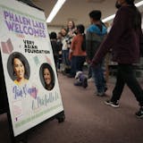 A welcome sign shows the faces of Gia Vang, former KARE-11 news anchor, and Michelle Li in the library of Phalen Lake Hmong Studies Magnet school.