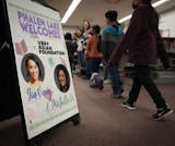 A welcome sign shows the faces of Gia Vang, former KARE-11 news anchor, and Michelle Li in the library of Phalen Lake Hmong Studies Magnet school.
