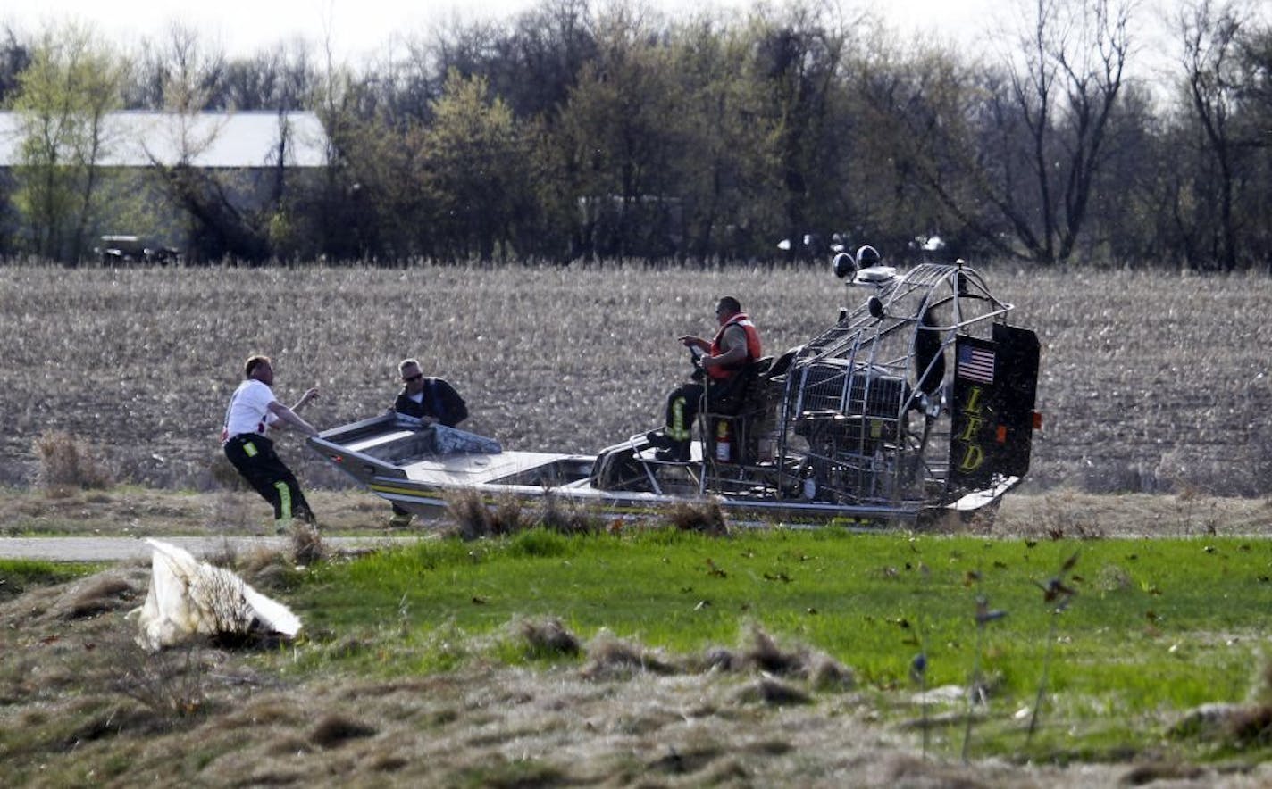 Authorities work to get an air boat into a swampy area a few hundred yards from the house of Aaron Schnagl where a body was found and is presumed to be Danielle Jelinek's in Chisago City, MN.