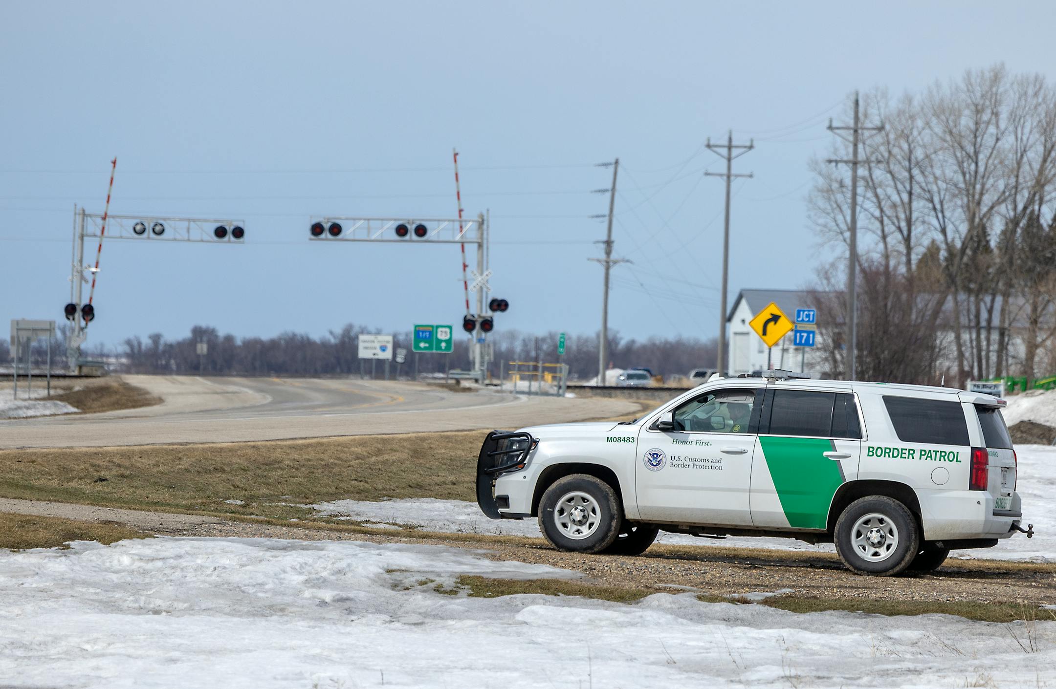 A border patrol agent sits on patrol near a railroad and rural road outside Pembina, Minn., on Monday, March 21, 2022.