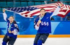 Kendall Coyne (26) and Hilary Knight (21) celebrated after receiving their Olympic gold medals.